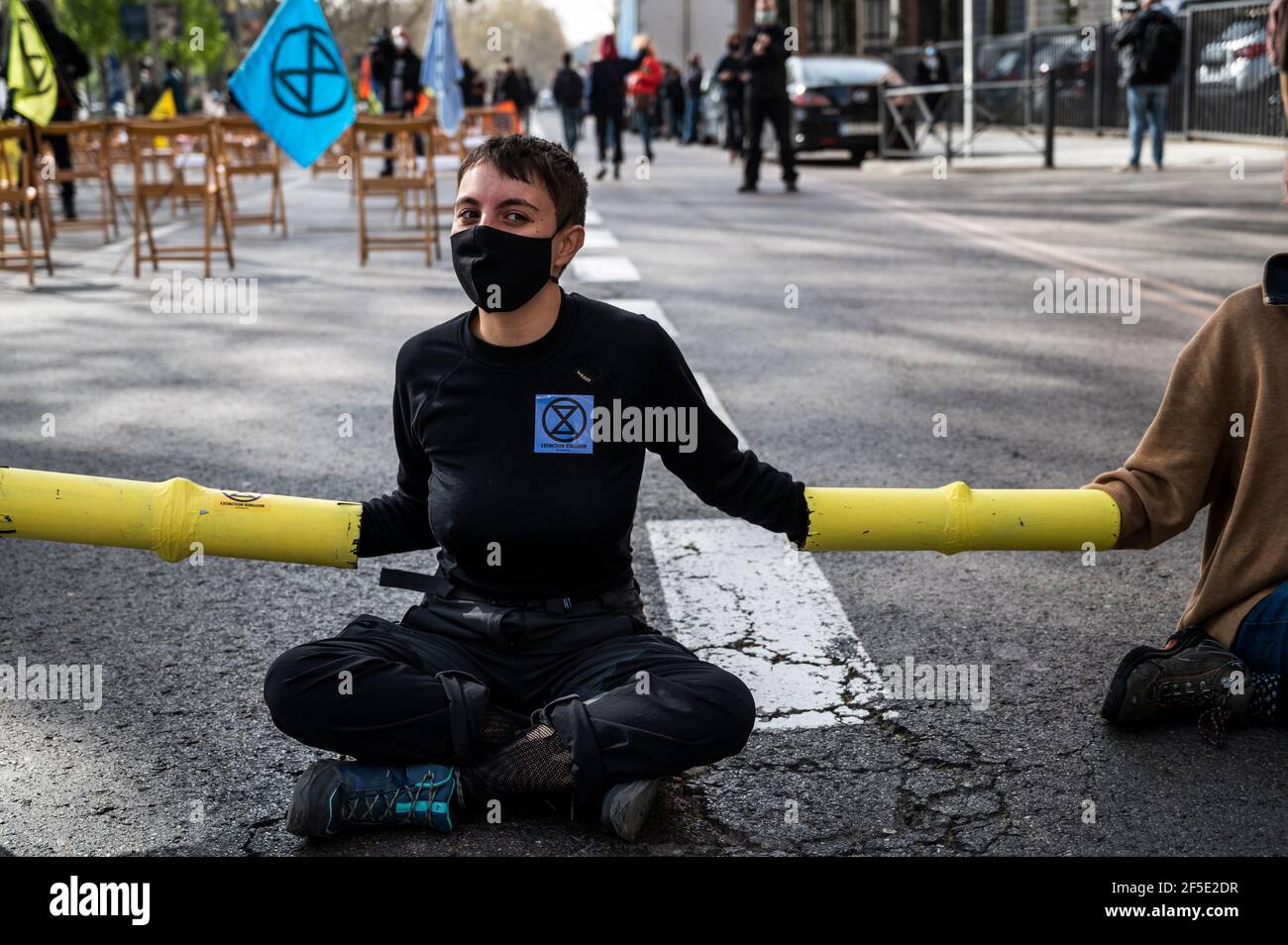 Madrid, Spain. 26th Mar, 2021. Climate change activists of Extinction Rebellion (XR) group chained themselves blocking the street in front of the Health Ministry, during a protest demanding actions against climate change. Credit: Marcos del Mazo/Alamy Live News Stock Photo