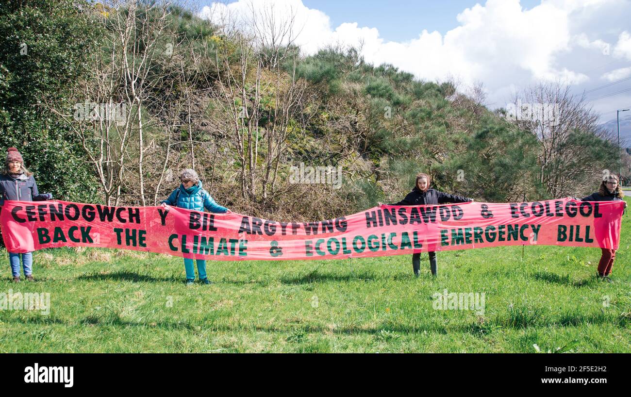 One Stop roundabout, Bethesda, Gwynedd, North Wales, UK. 26th March 2021. Members of Extinction Rebellion North Wales hold a banner calling for the backing of the Climate and Ecological Emergency bill.as part of a national banner drop day of action.Parliament declared a Climate Emergency back in 2019 – but protestors say actions haven’t matched their words. An emergency requires strong, decisive action to reverse the climate and ecological crisis. Stock Photo