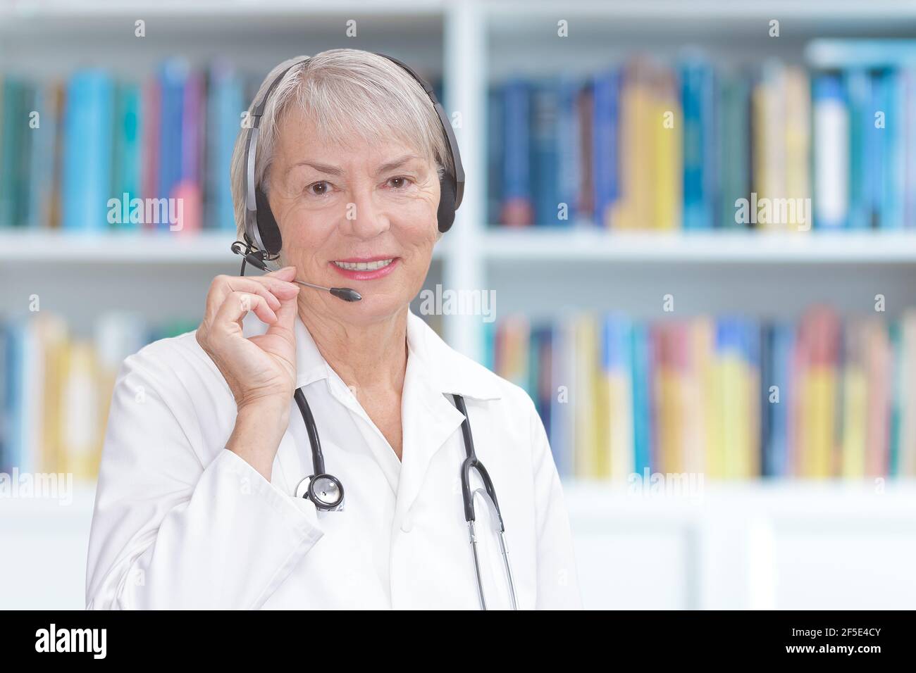 Webcam view of a doctor with headset during a video consultation, telemedicine or telehealth concept. Stock Photo
