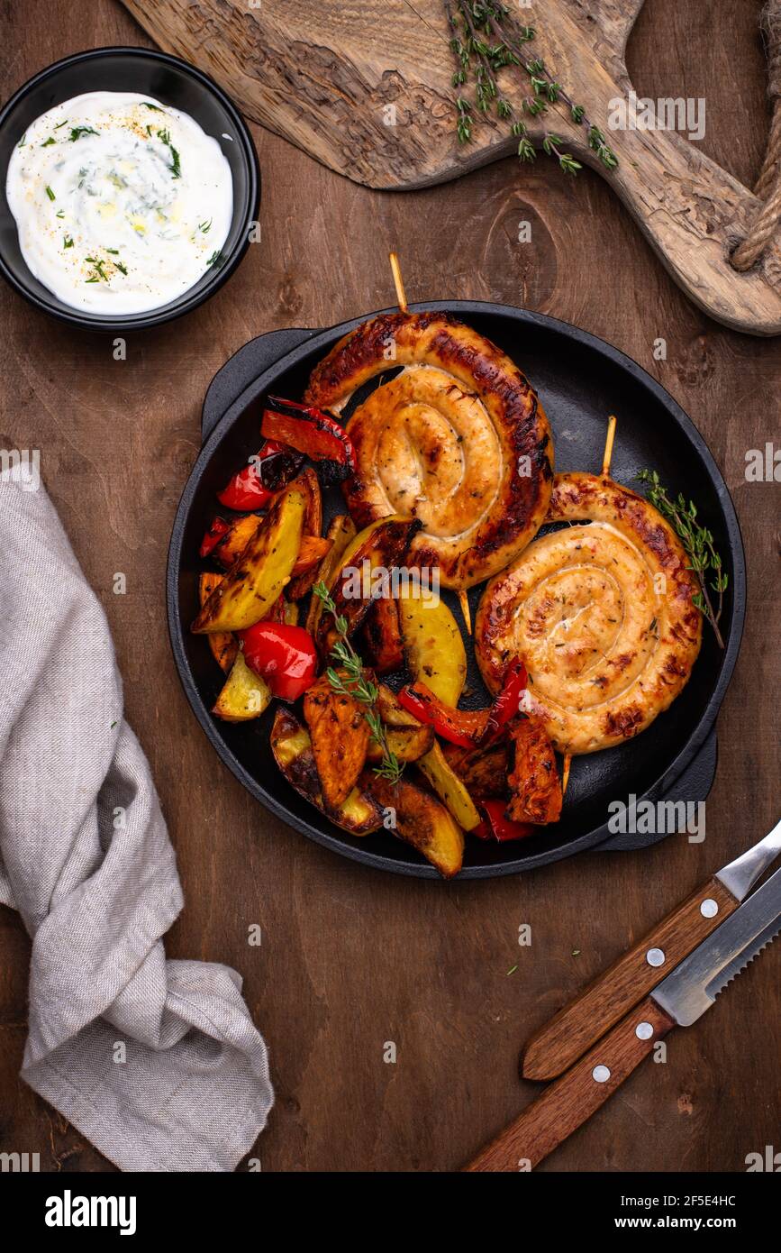 Baked chicken sausages with vegetables Stock Photo Alamy