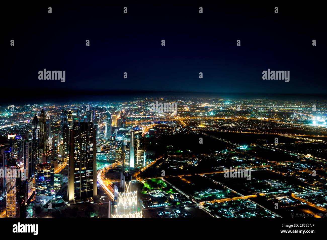 Cityscape of Dubai covered in skyscrapers and bright lights at night in