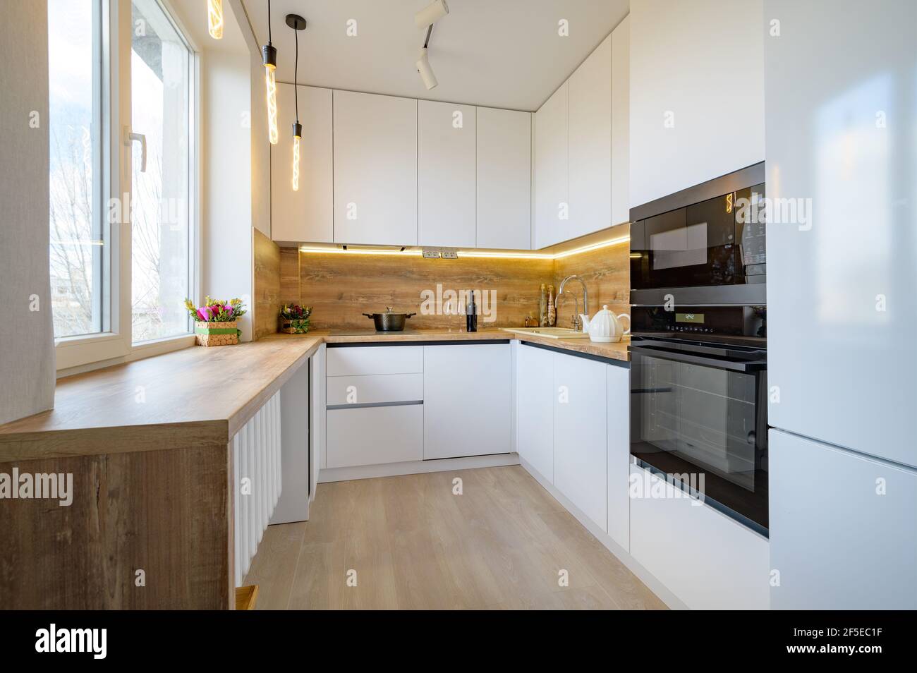 Modern white and beige wooden kitchen interior Stock Photo Alamy