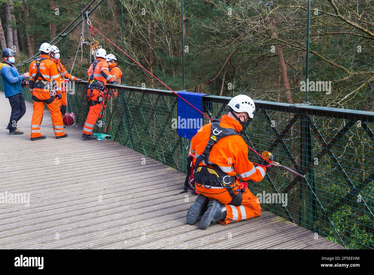 Dorset Fire Service carrying out training exercise on suspension bridge at Alum Chine, Bournemouth, Dorset UK in March during Covid-19 lockdown Stock Photo
