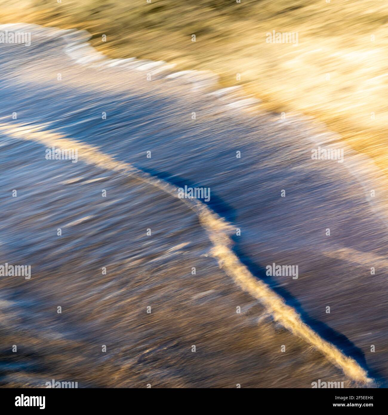 abstract landscape of sea. texture water and sand in blurry motion in the golden hour Stock Photo