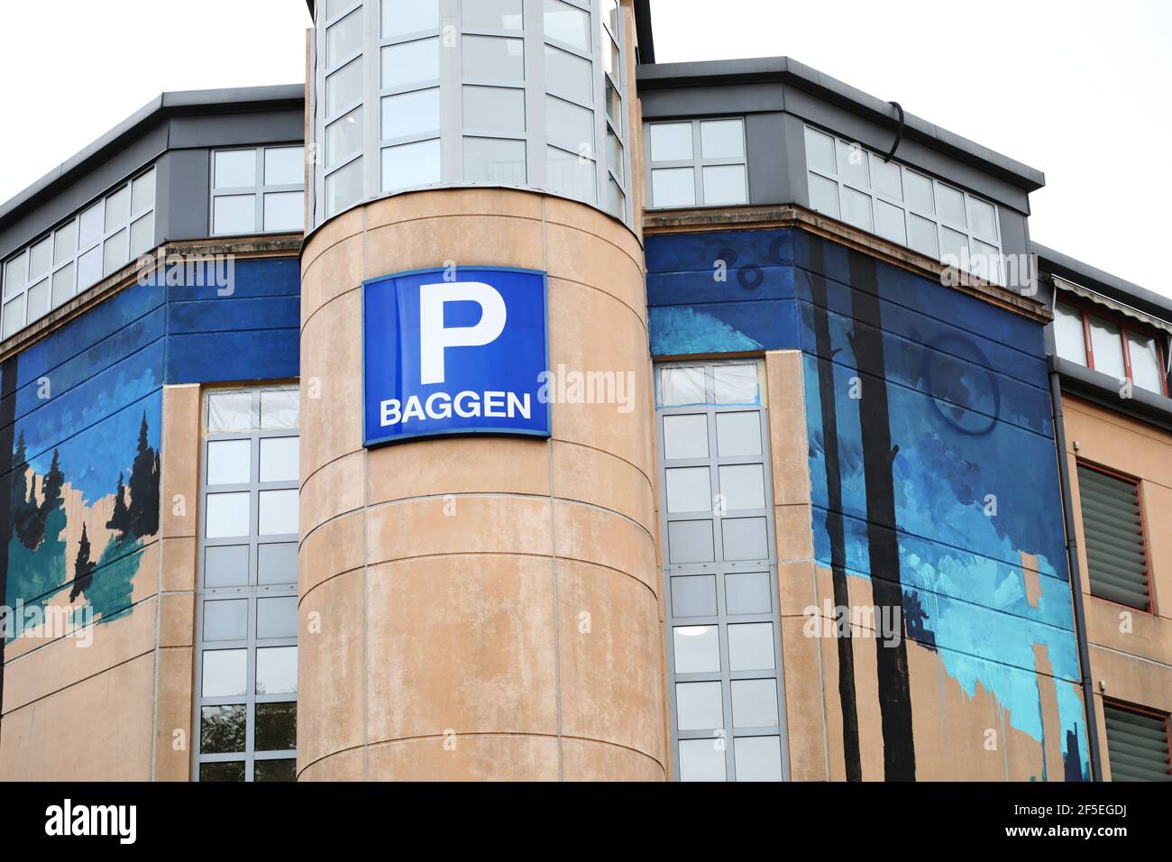 This week, the street art project ARTSCAPE FORM officially started in Östergötland. The picture: The artist Adrian P paints on the wall of a parking garage in central Linköping. Stock Photo