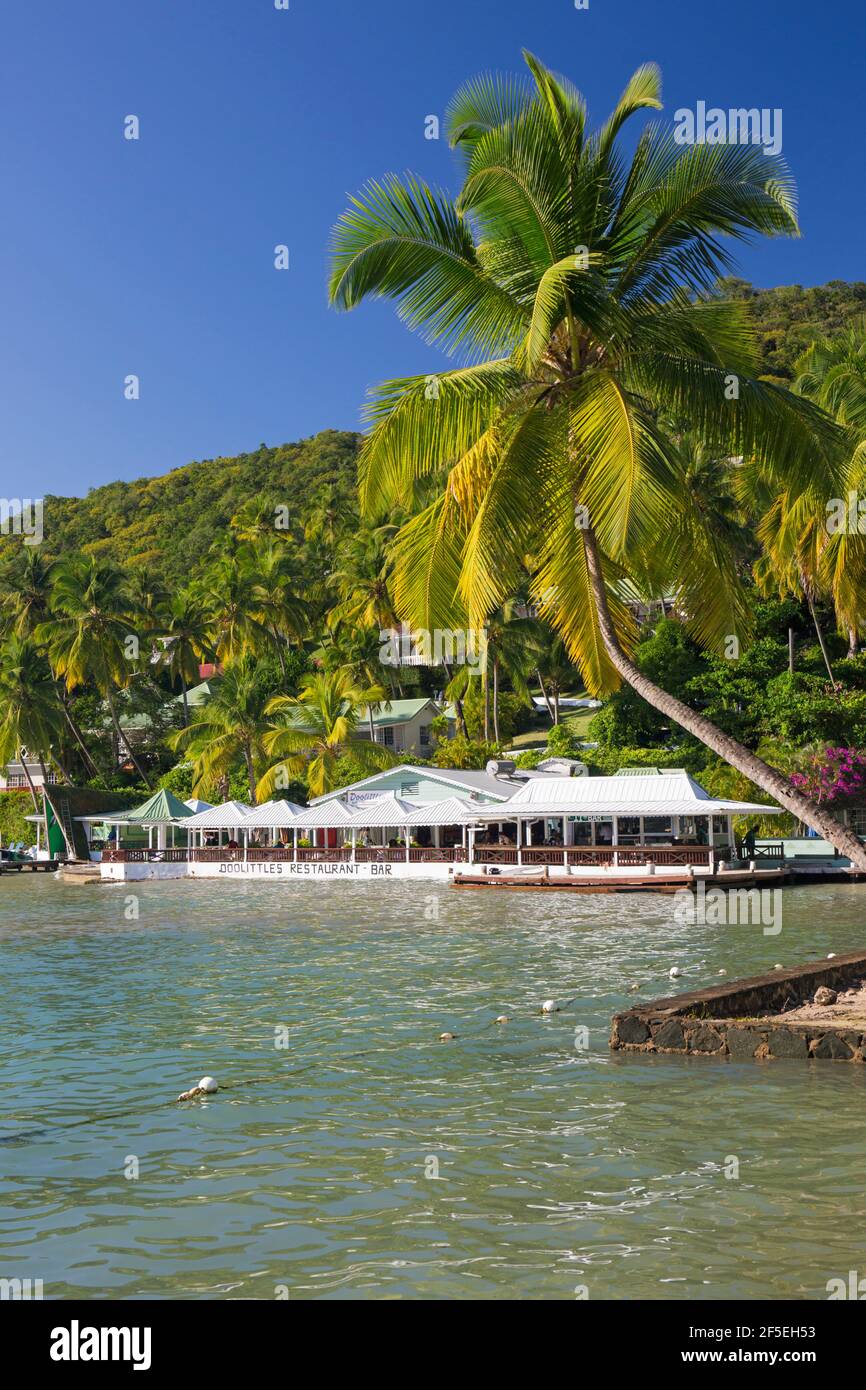 Marigot Bay, Castries, St Lucia. The Caribbean Sea off LaBas Beach, coconut palms growing on shore. Stock Photo