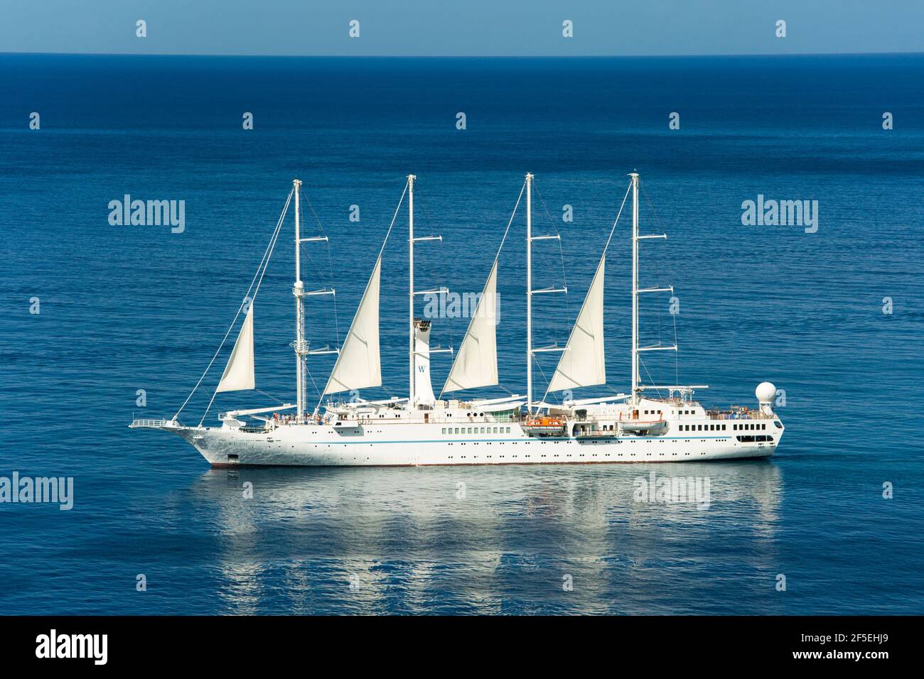 Soufriere, St Lucia. Four-masted luxury cruise ship, the Wind Star, under sail in Soufriere Bay. Stock Photo