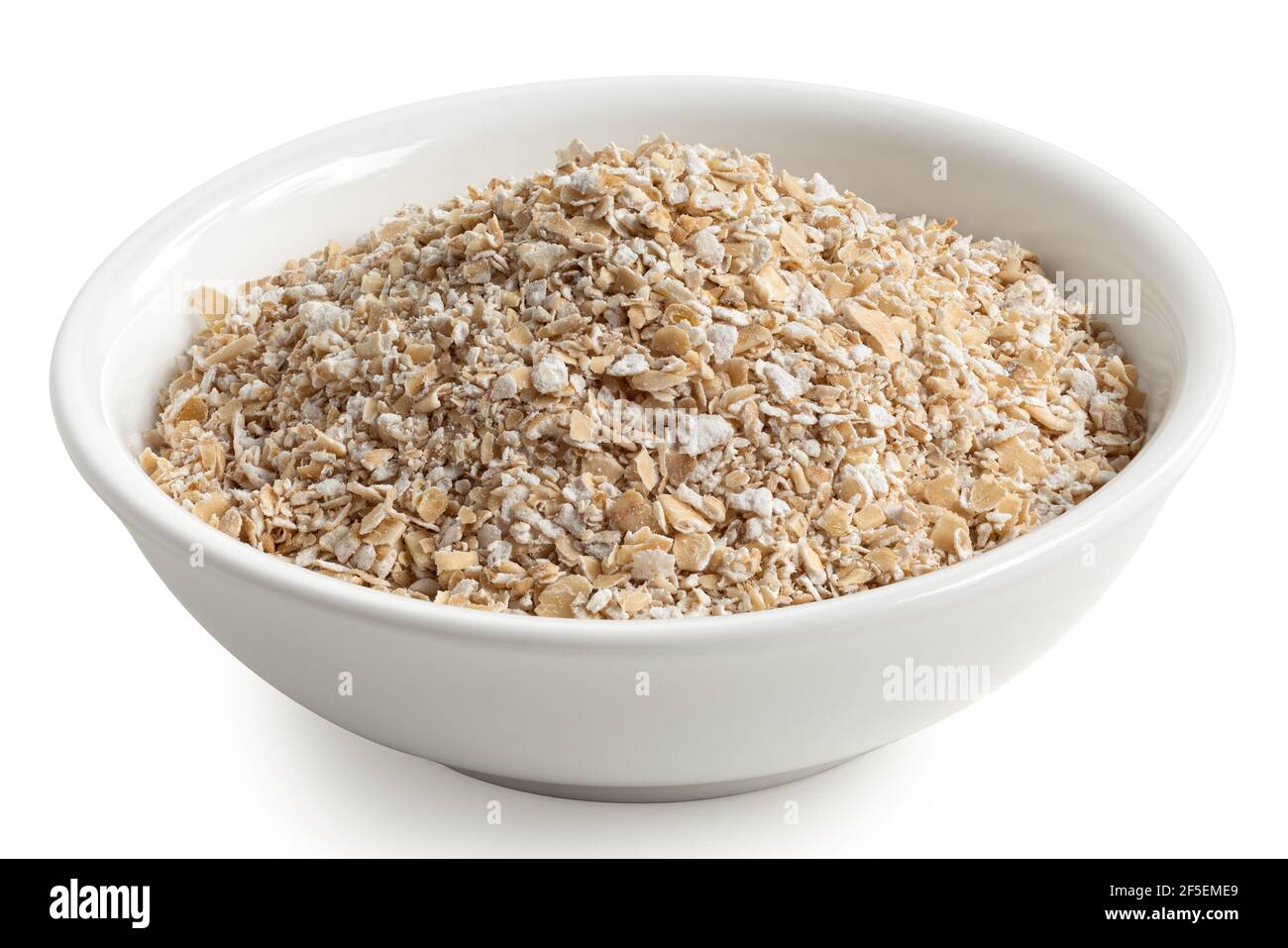 Uncooked coarse oatmeal in a white ceramic bowl isolated on white. Stock Photo