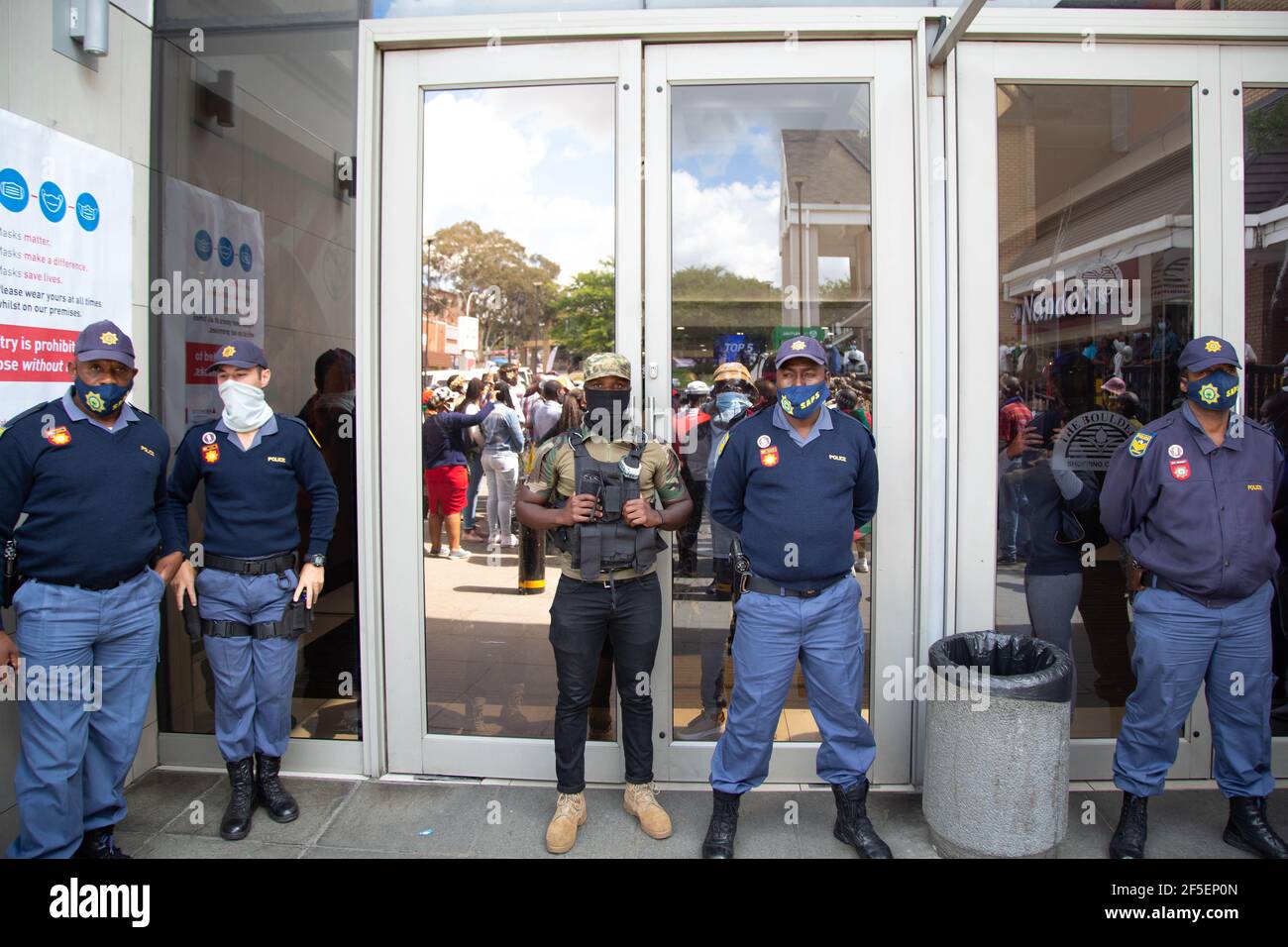 Johannesburg, South Africa. 26th Mar, 2021. Police and security stand