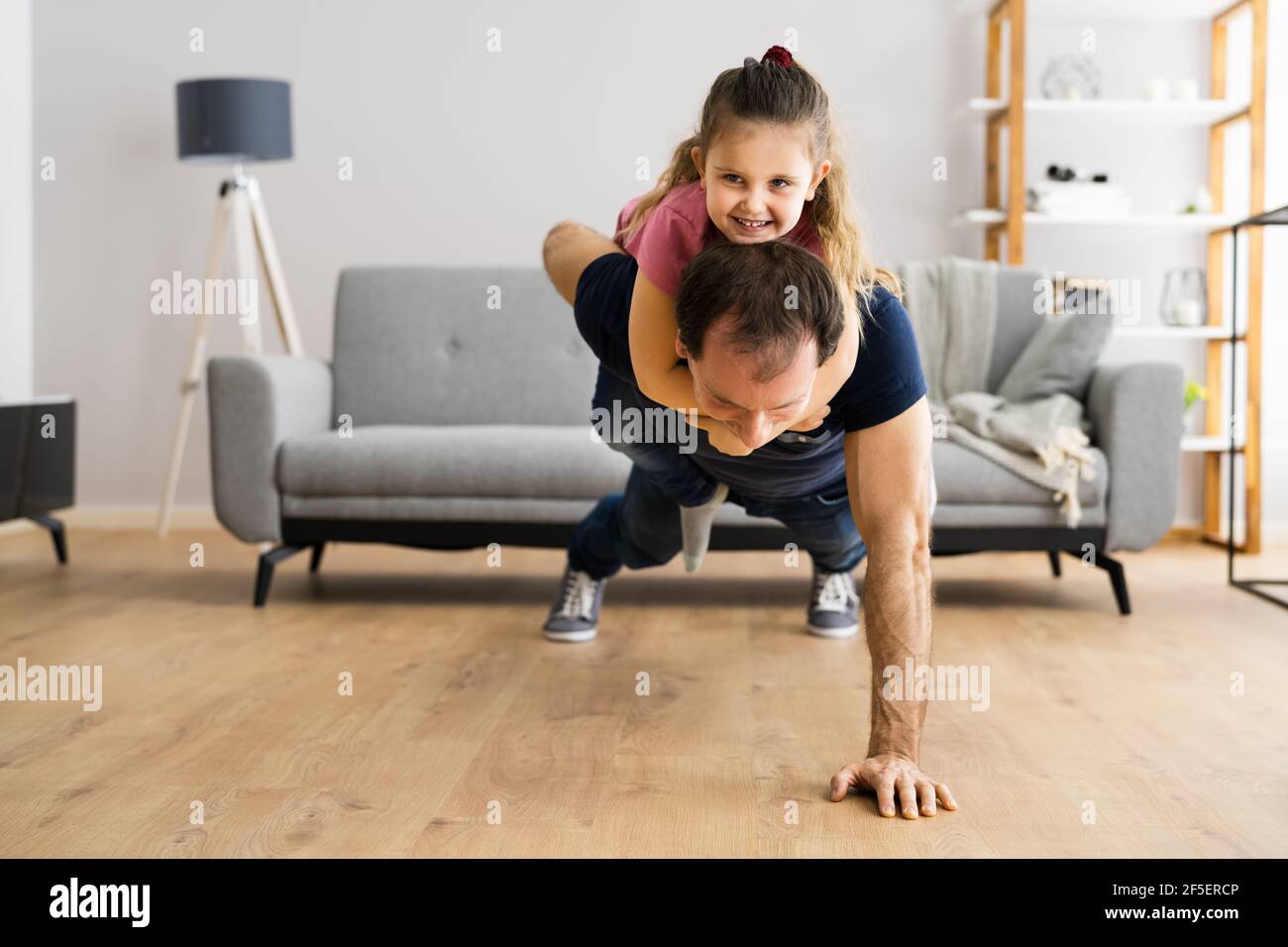Happy Family With Child Fitness Training Exercise Stock Photo