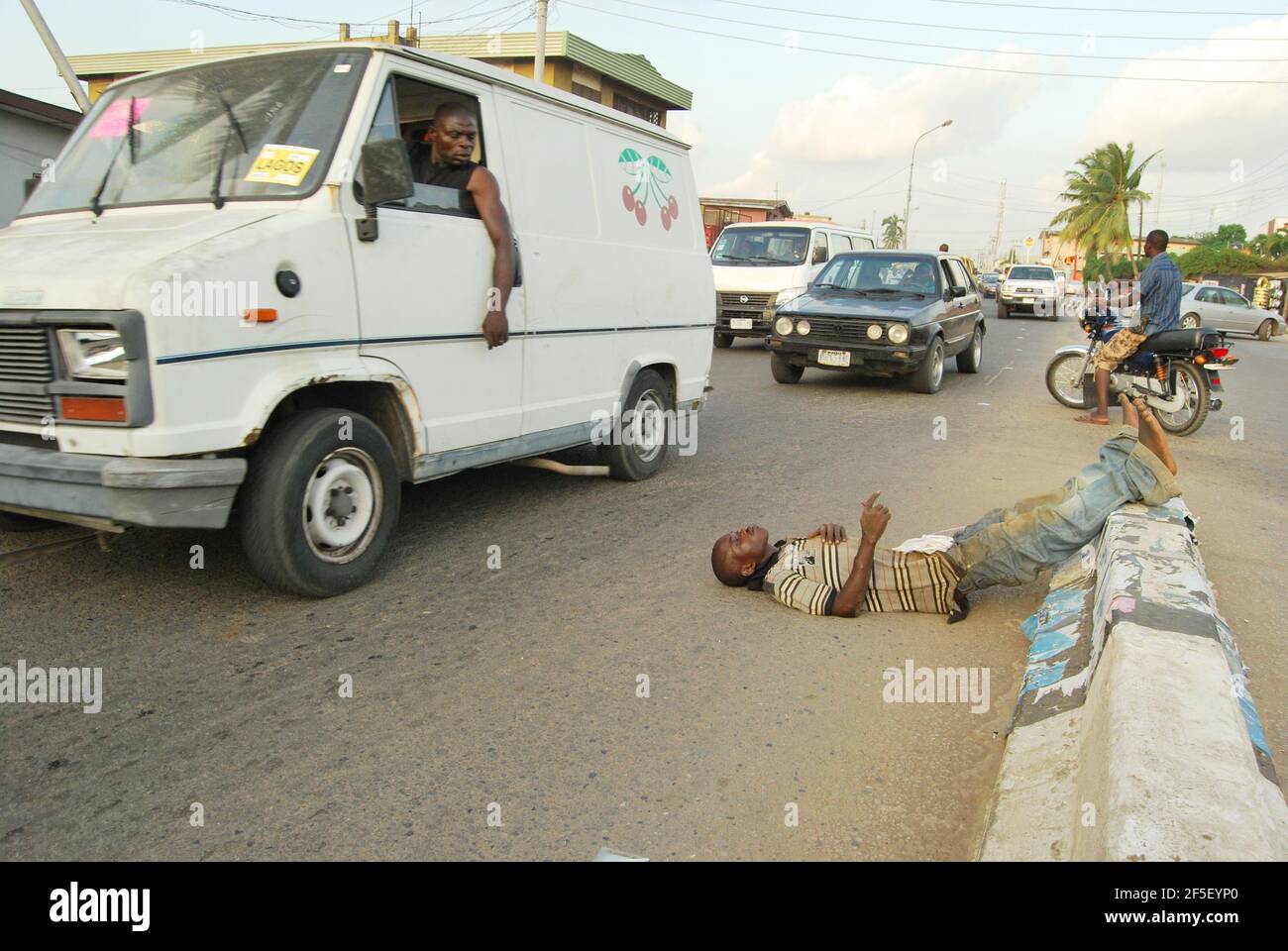 37. Lagos Metro: Drunker sleeping on Lagos road. Stock Photo
