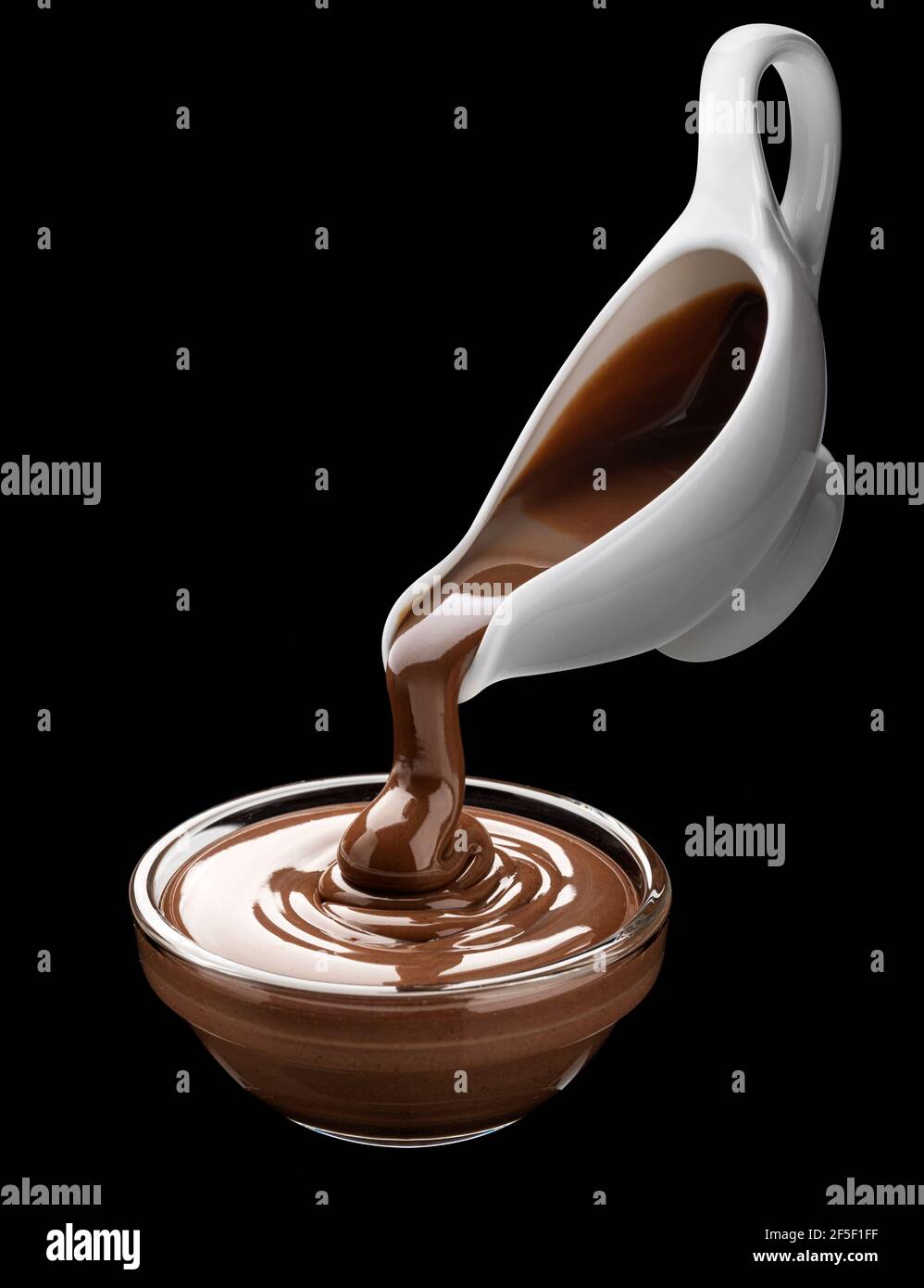 Pouring melted chocolate on black background Stock Photo