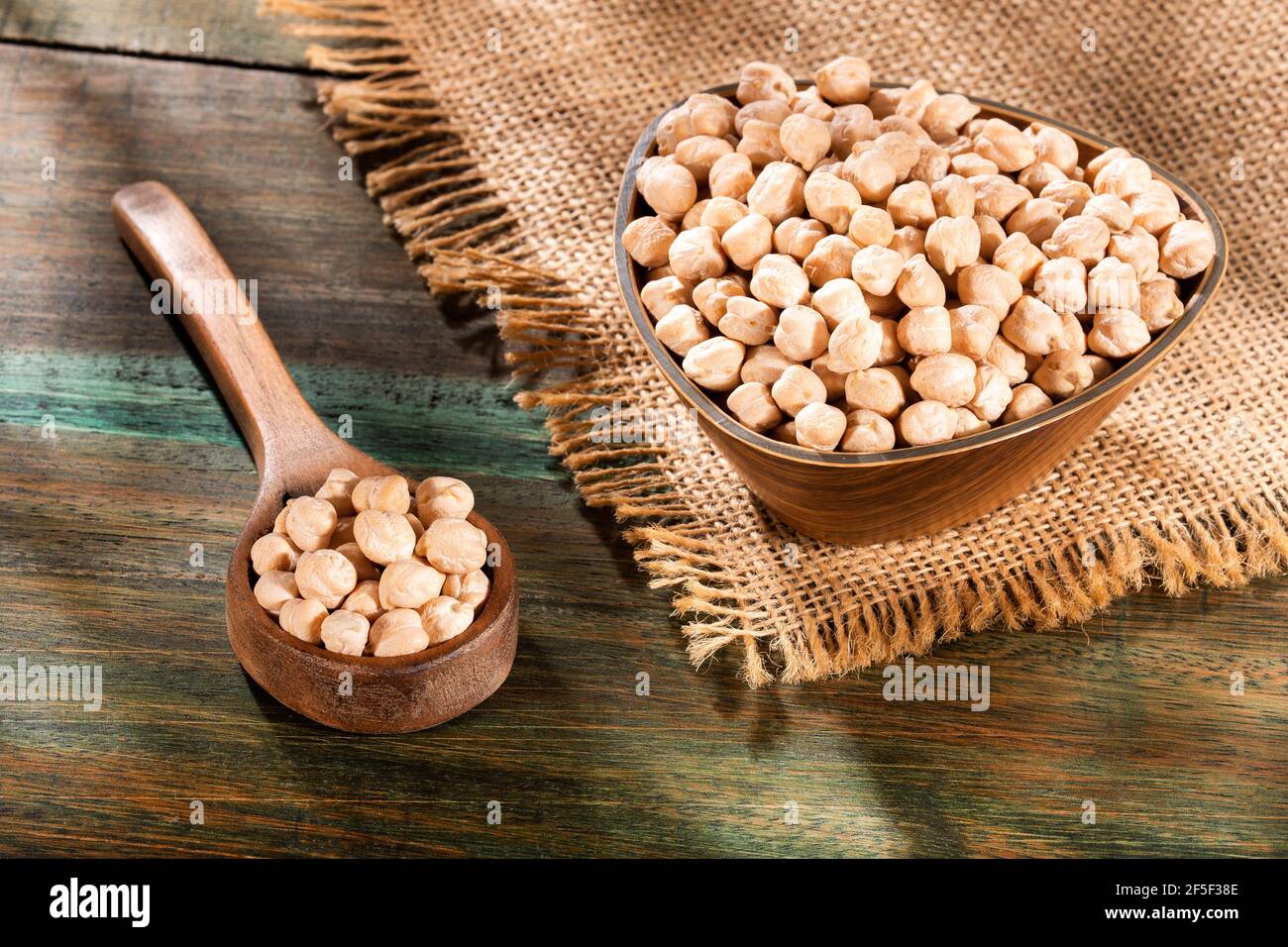 Cicer arietinum - Raw chickpeas in the wooden bowl Stock Photo