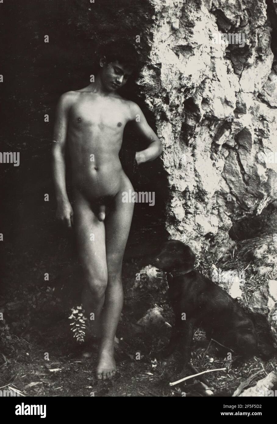 Boy standing near dog. Baron Wilhelm von Gloeden (German, 1856 - 1931) Stock Photo