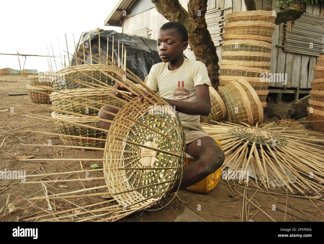 Nigerian children weaving basket in the outskirt of Ondo State, Nigeria
