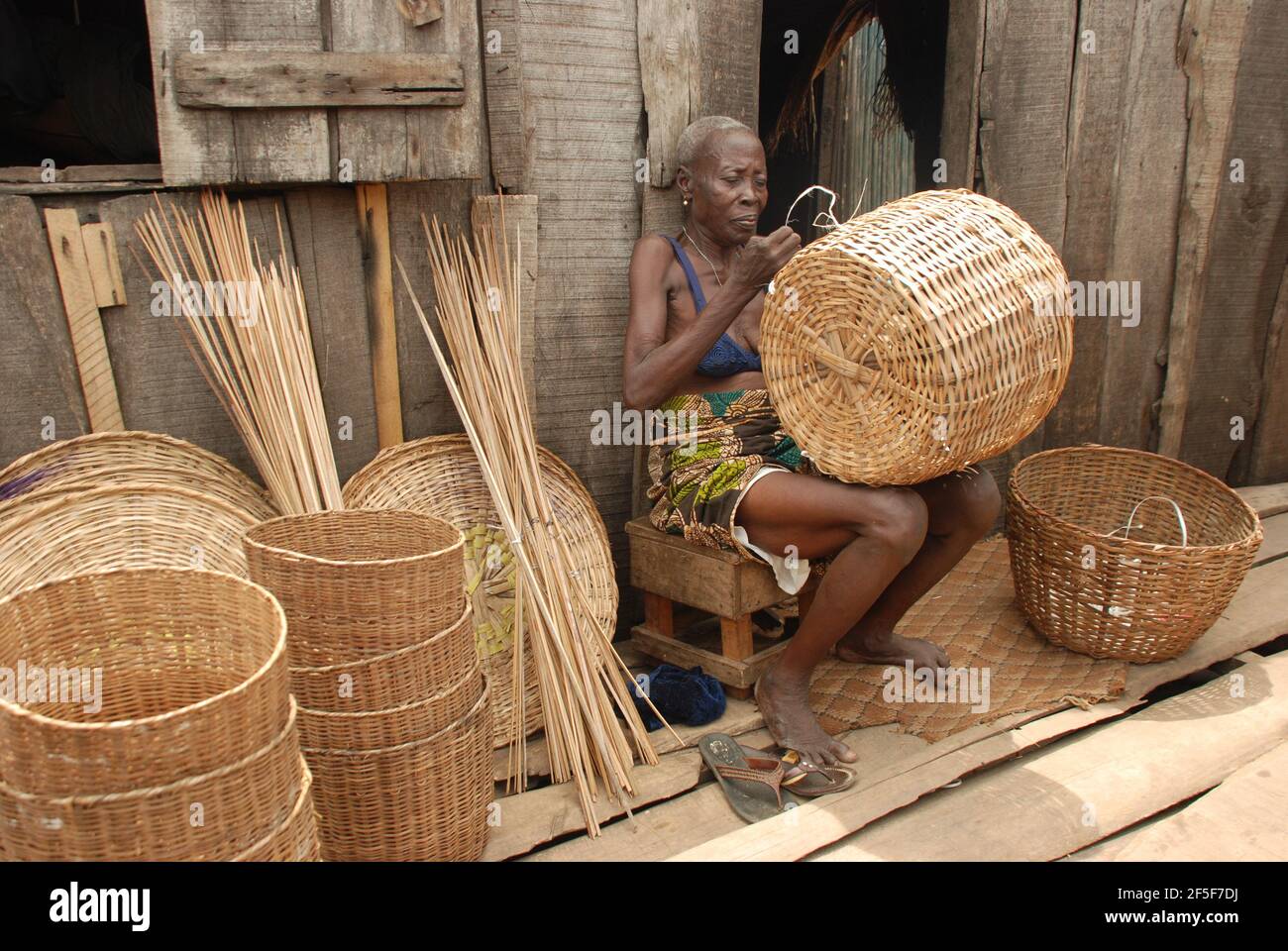 Nigerian woman weaving baskets in the outskirt of Lagos State, Nigeria. Stock Photo