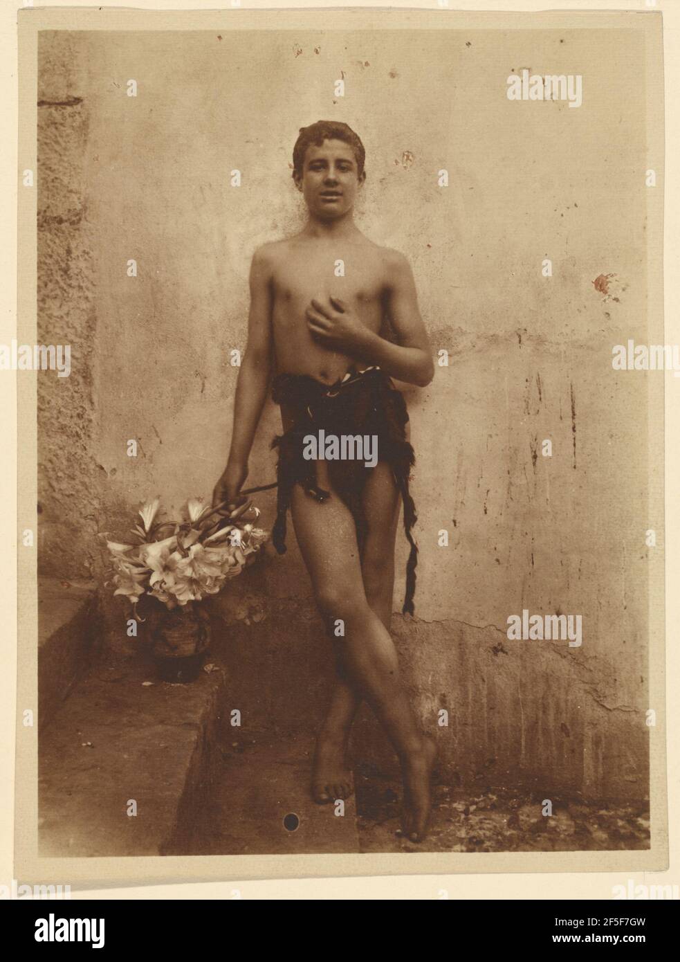 Youth with lillies. Baron Wilhelm von Gloeden (German, 1856 - 1931) Stock Photo