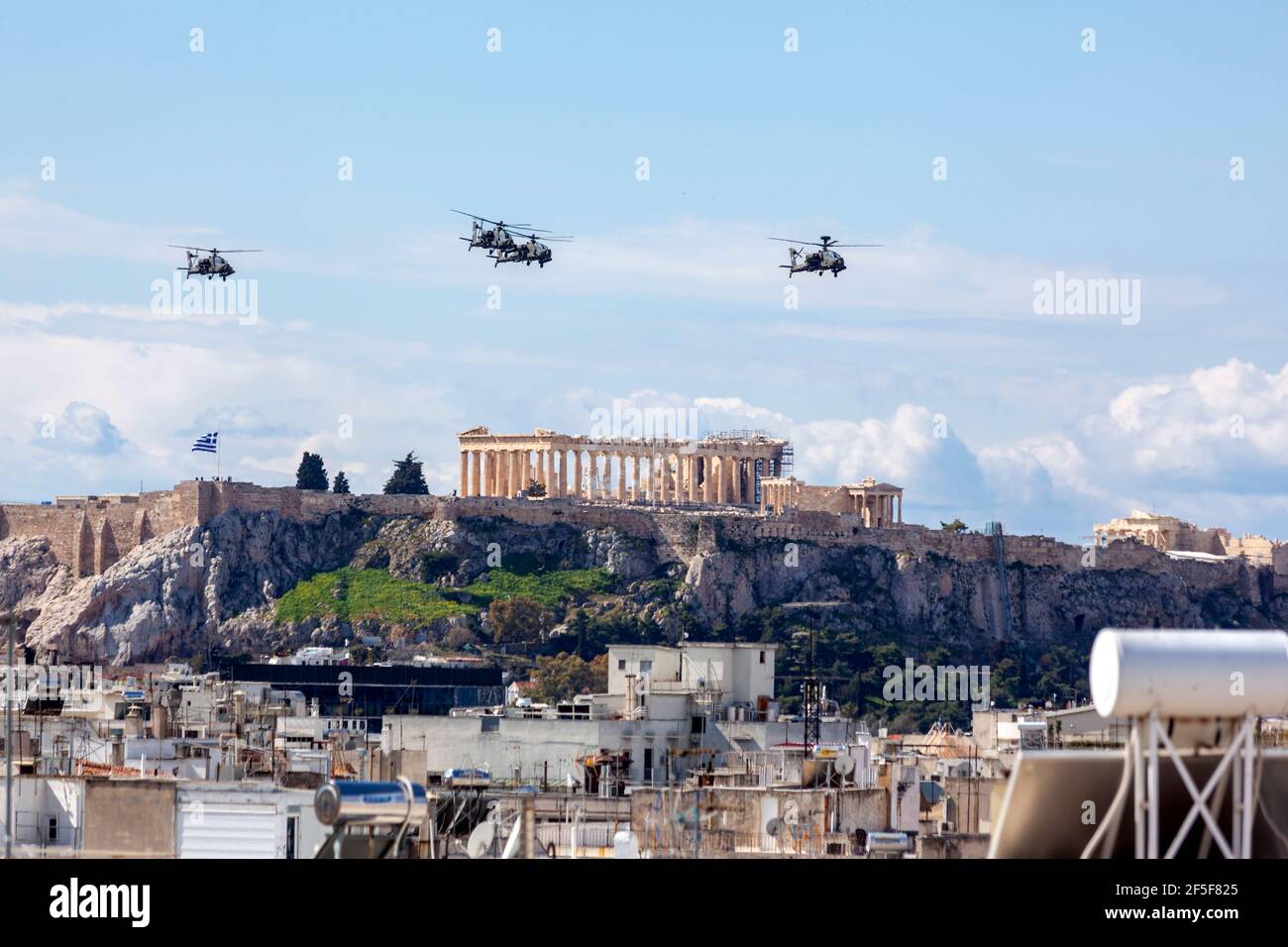 ΑΗ-64 Apache helicopters flying in formation above Akropolis, Athens, during the military parade for the 200 years of the Greek Independence War Stock Photo