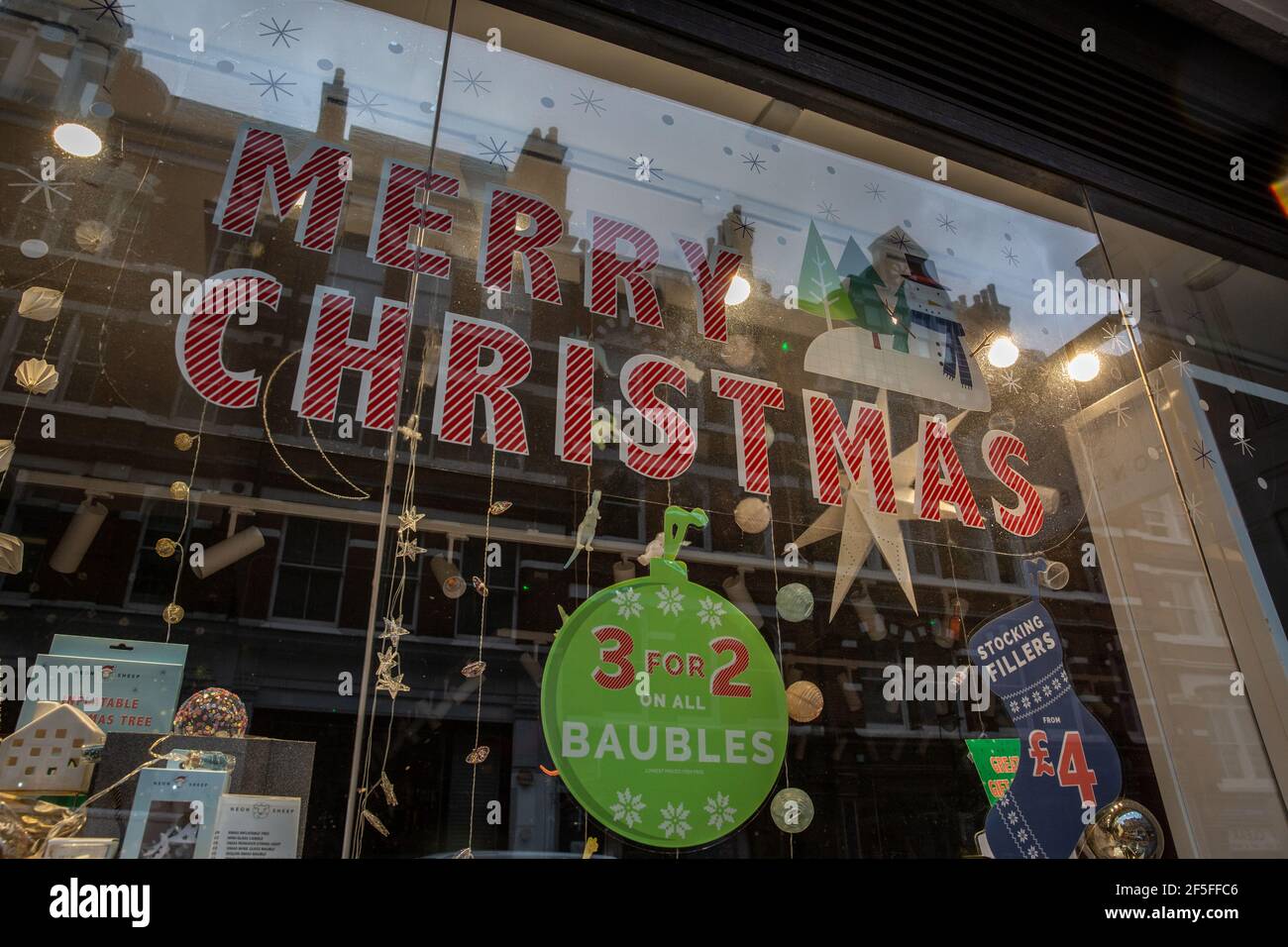 Shops continue to have Christmas decorations on their shop windows after retail shops were forced to close before Xmas due to coronavirus lockdown#3. Stock Photo