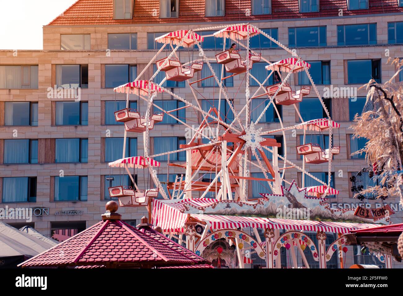 17 May 2019 Dresden, Germany - Ferris wheel at Altmarkt in morning. Trade center on background. Stock Photo