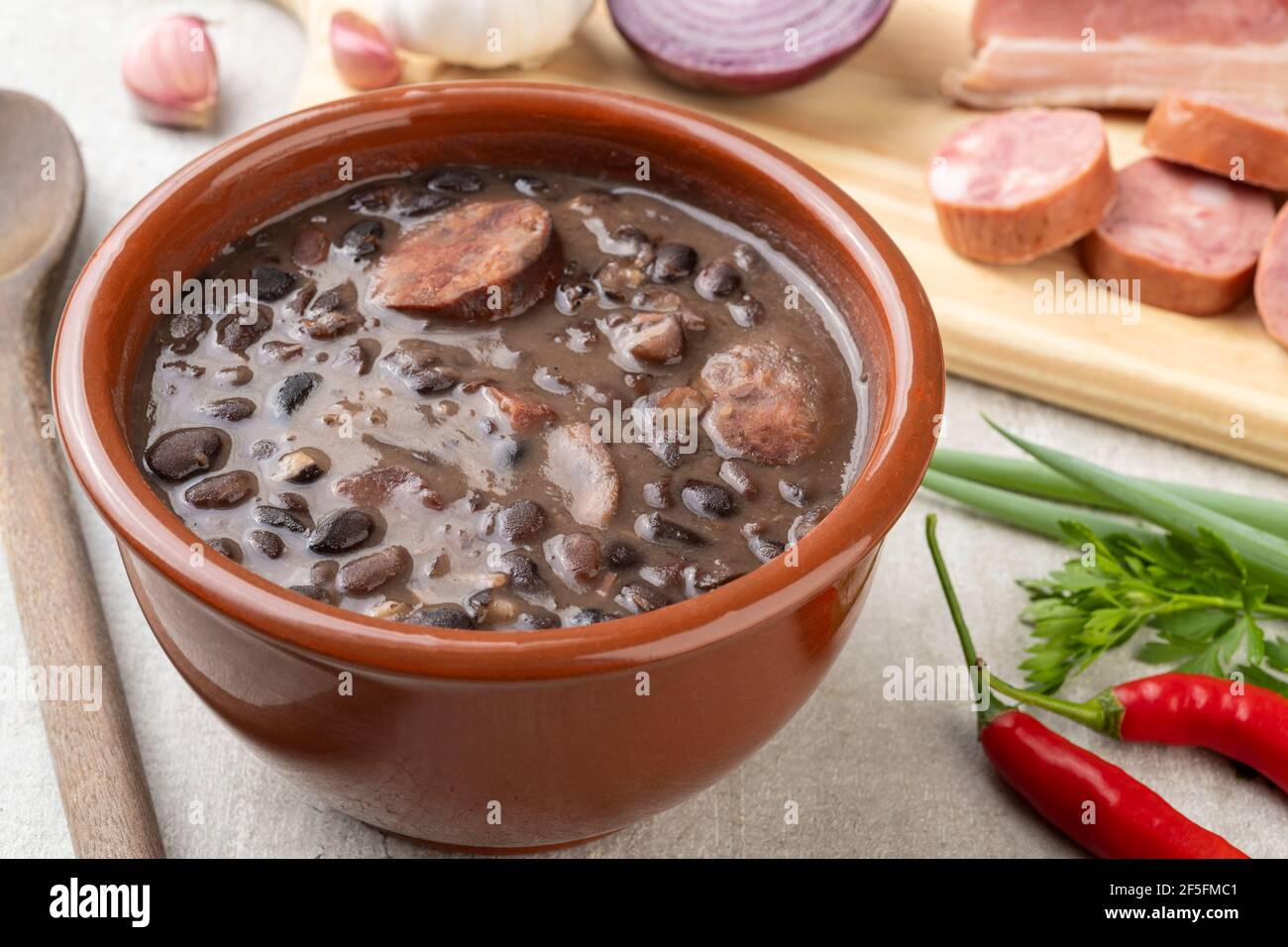 Traditional brazilian feijoada in a bowl with ingredients Stock Photo ...