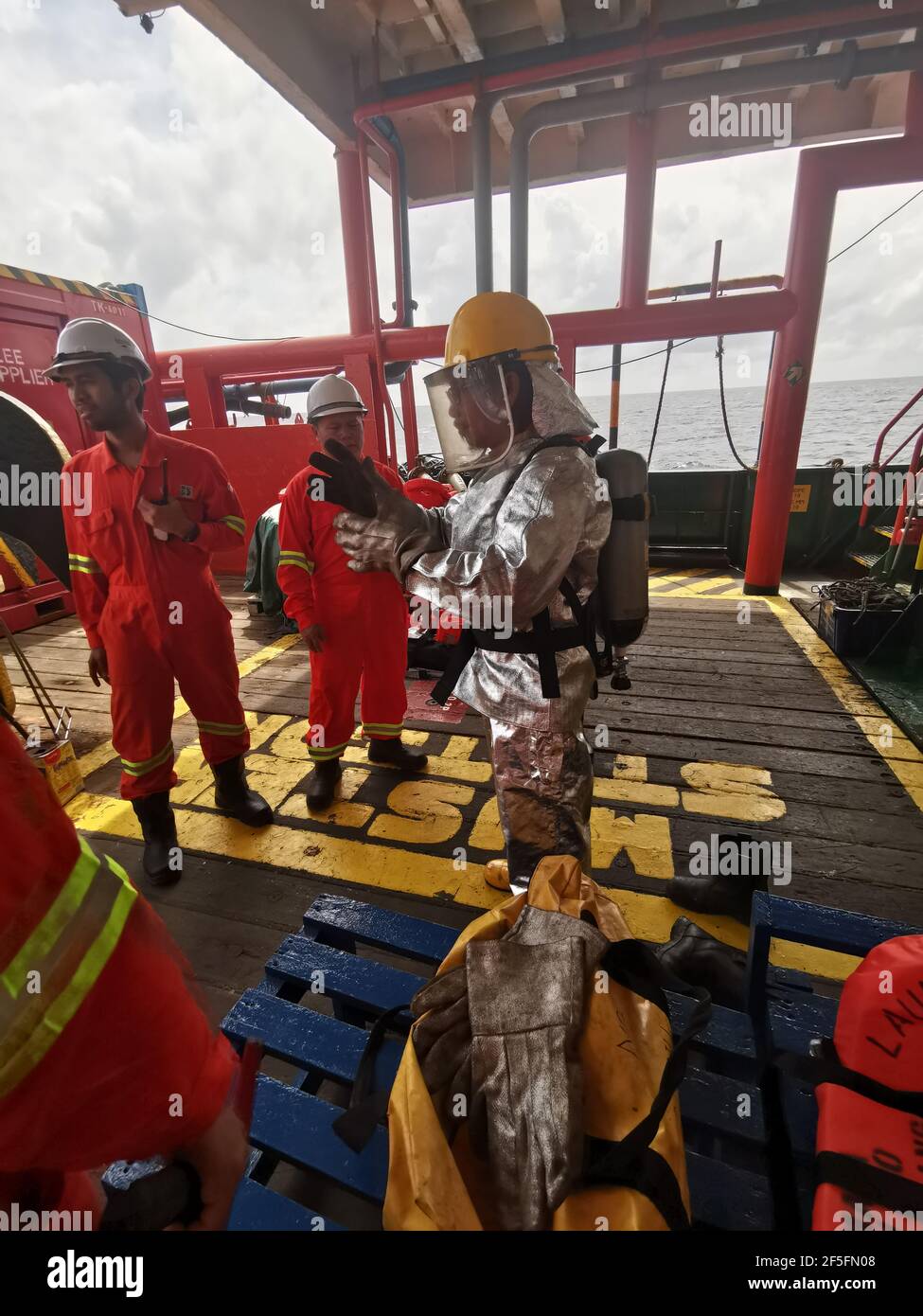 seafarer carried out monthly fire drill on deck, to refresh their training and test all emergency fire pump and fire hose Stock Photo