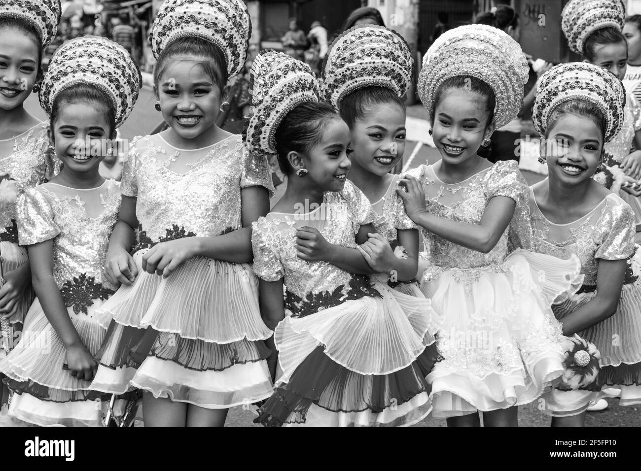 A Group Of Filipino Elementary Schoolchildren Pose For A Photo During The Drum & Bugle Corps Contest, Dinagyang Festival, Iloilo City, The Philippines. Stock Photo