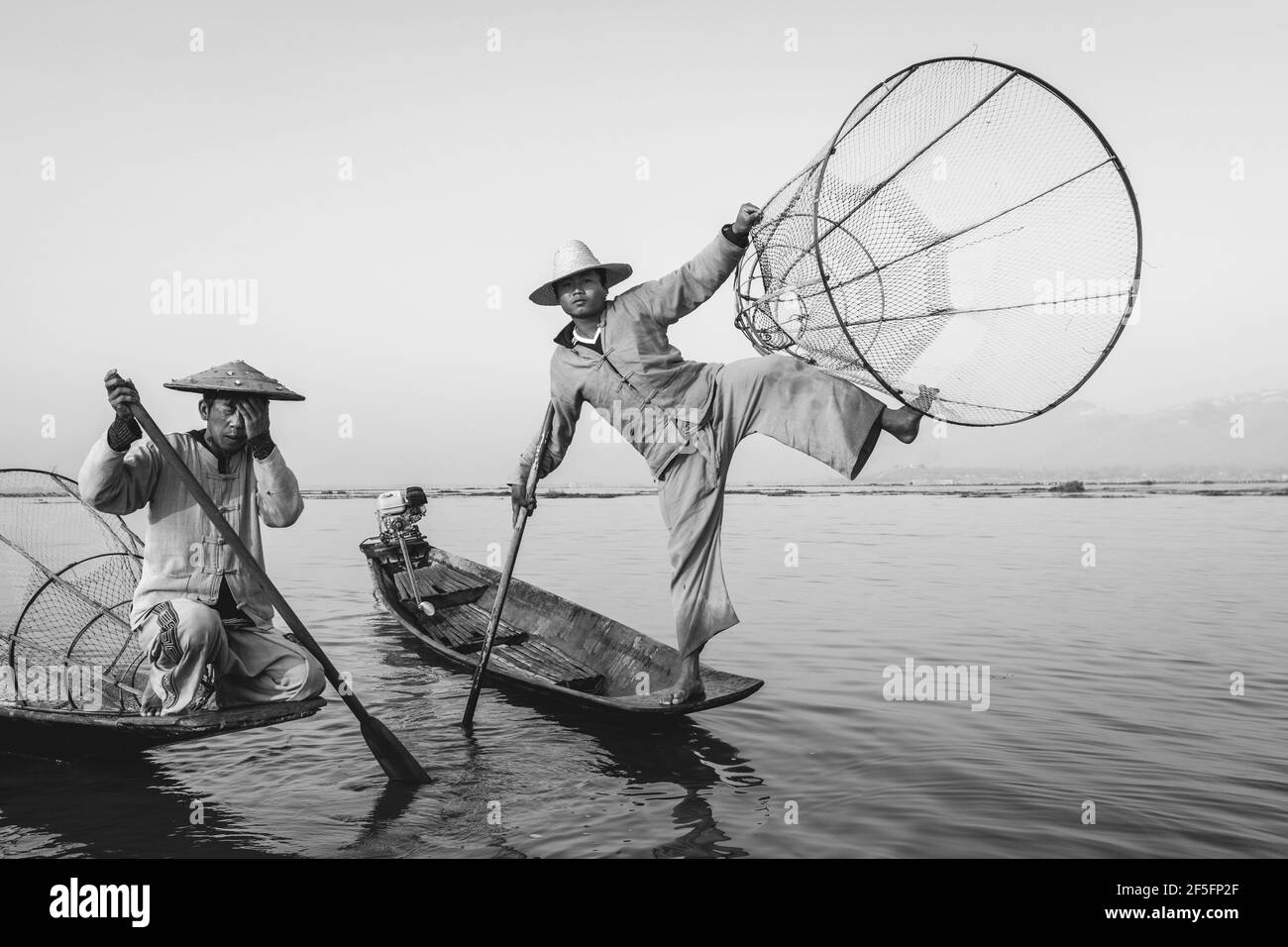 Two men fishing at sunrise Black and White Stock Photos & Images - Alamy