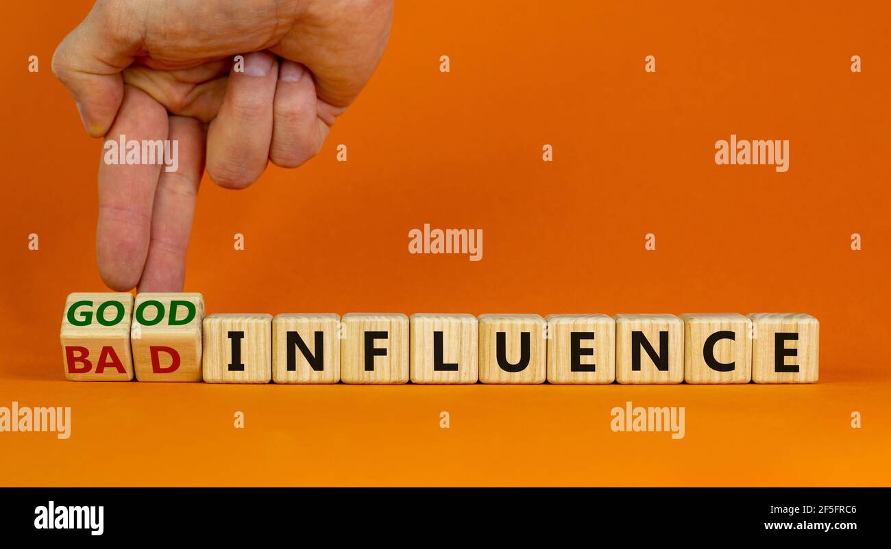 Good or bad influence symbol. Businessman turns cubes and changes words