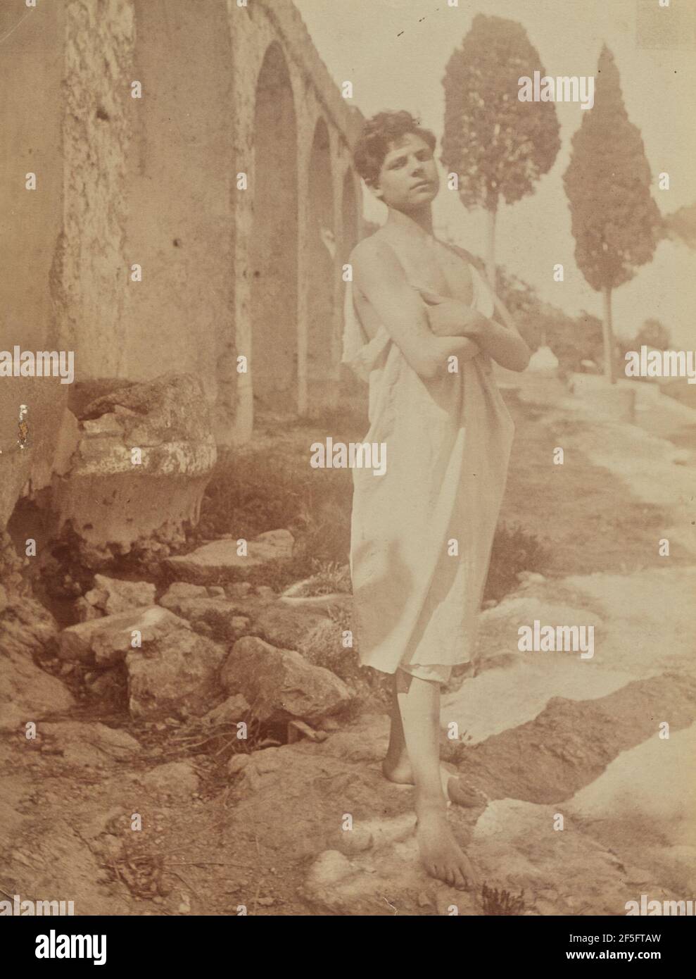 Young man posed at Greek theater. Baron Wilhelm von Gloeden (German, 1856 - 1931) Stock Photo