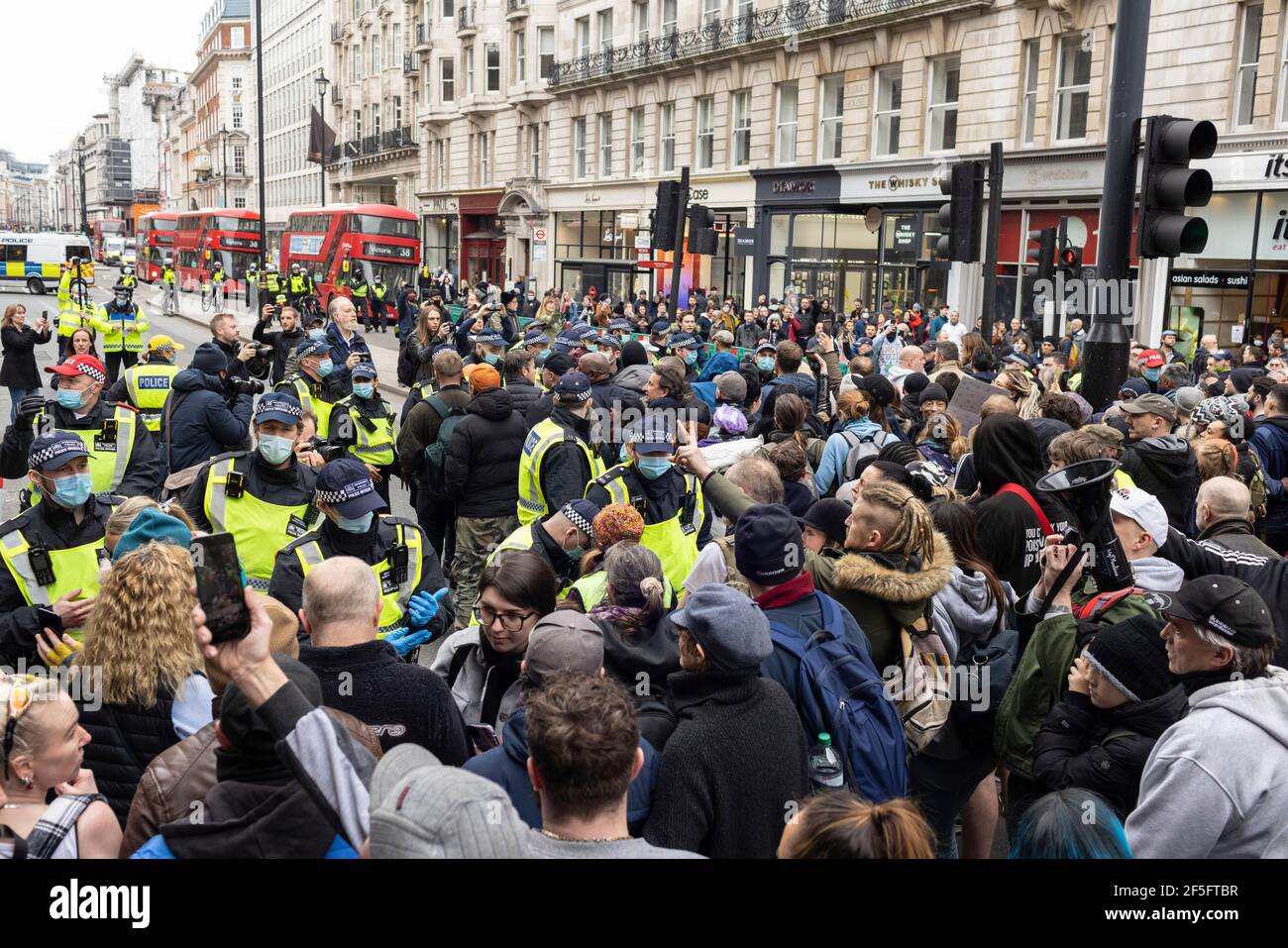 Anti-lockdown and anti Covid-19 vaccination protest, London, 20 March 2021. Police clashing with protesters. Stock Photo