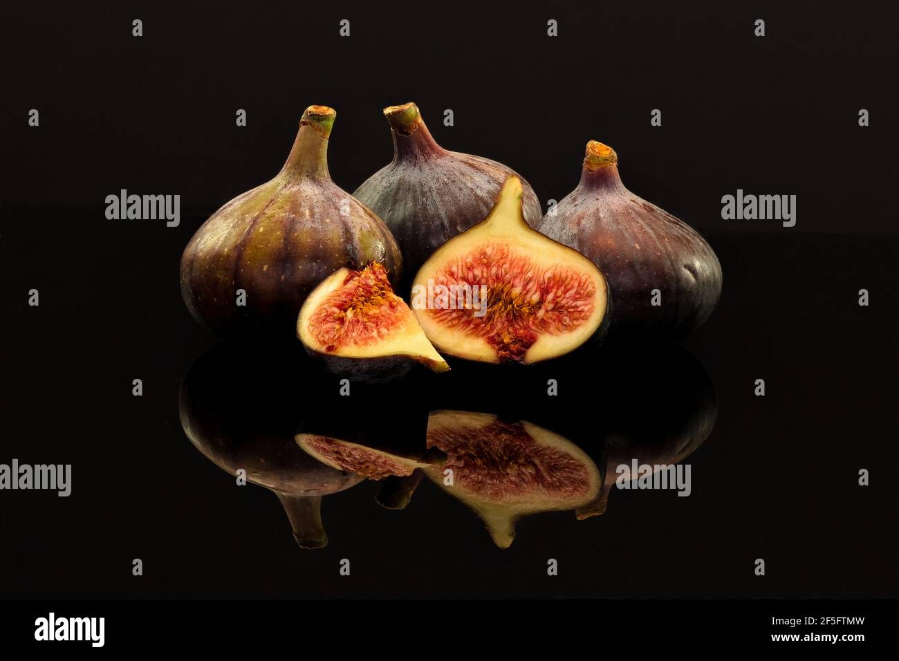 Fresh Figs on a shiny black surface Stock Photo