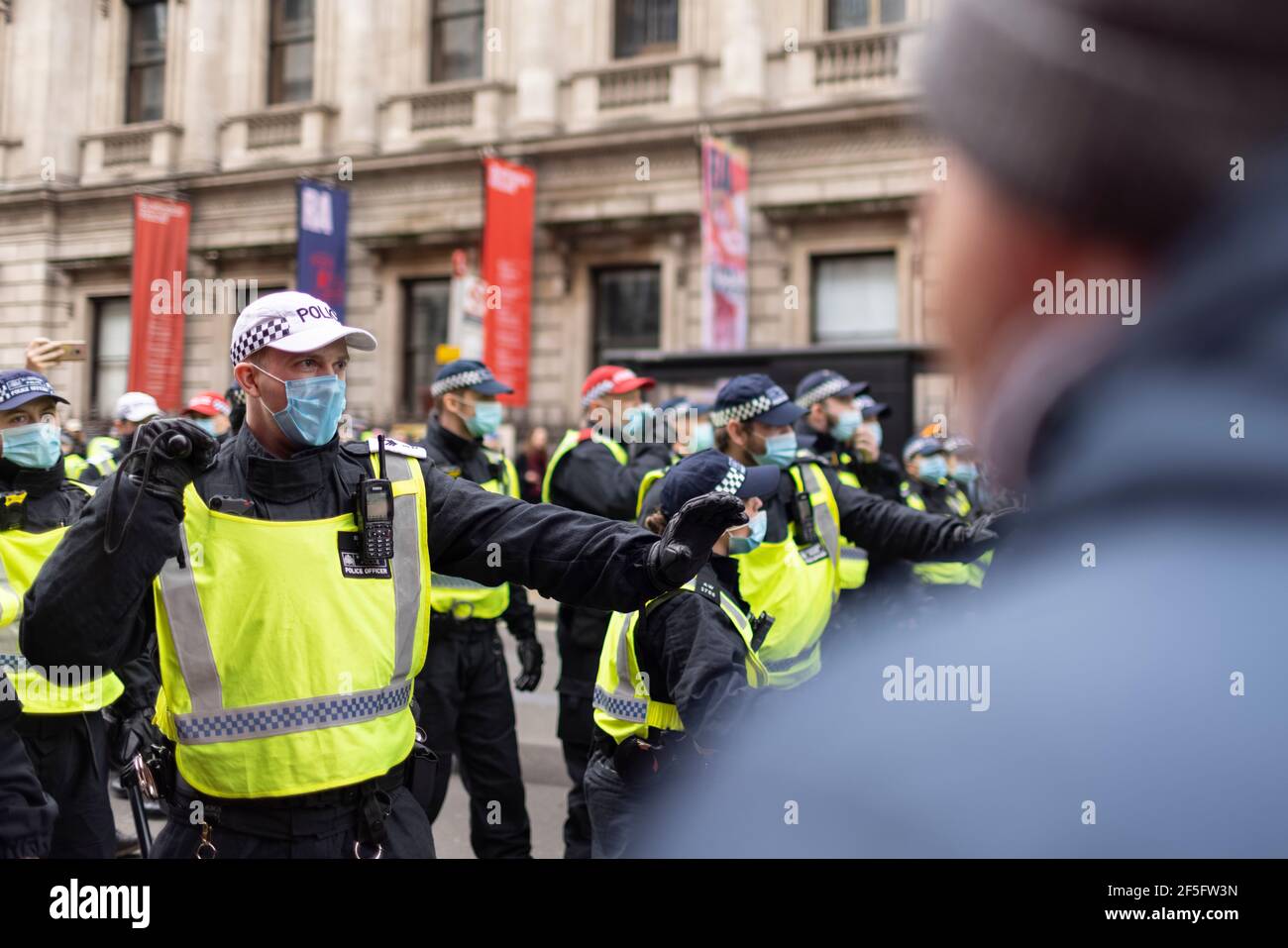 Anti-lockdown and anti Covid-19 vaccination protest, London, 20 March 2021. Confrontation between police and protesters. Stock Photo