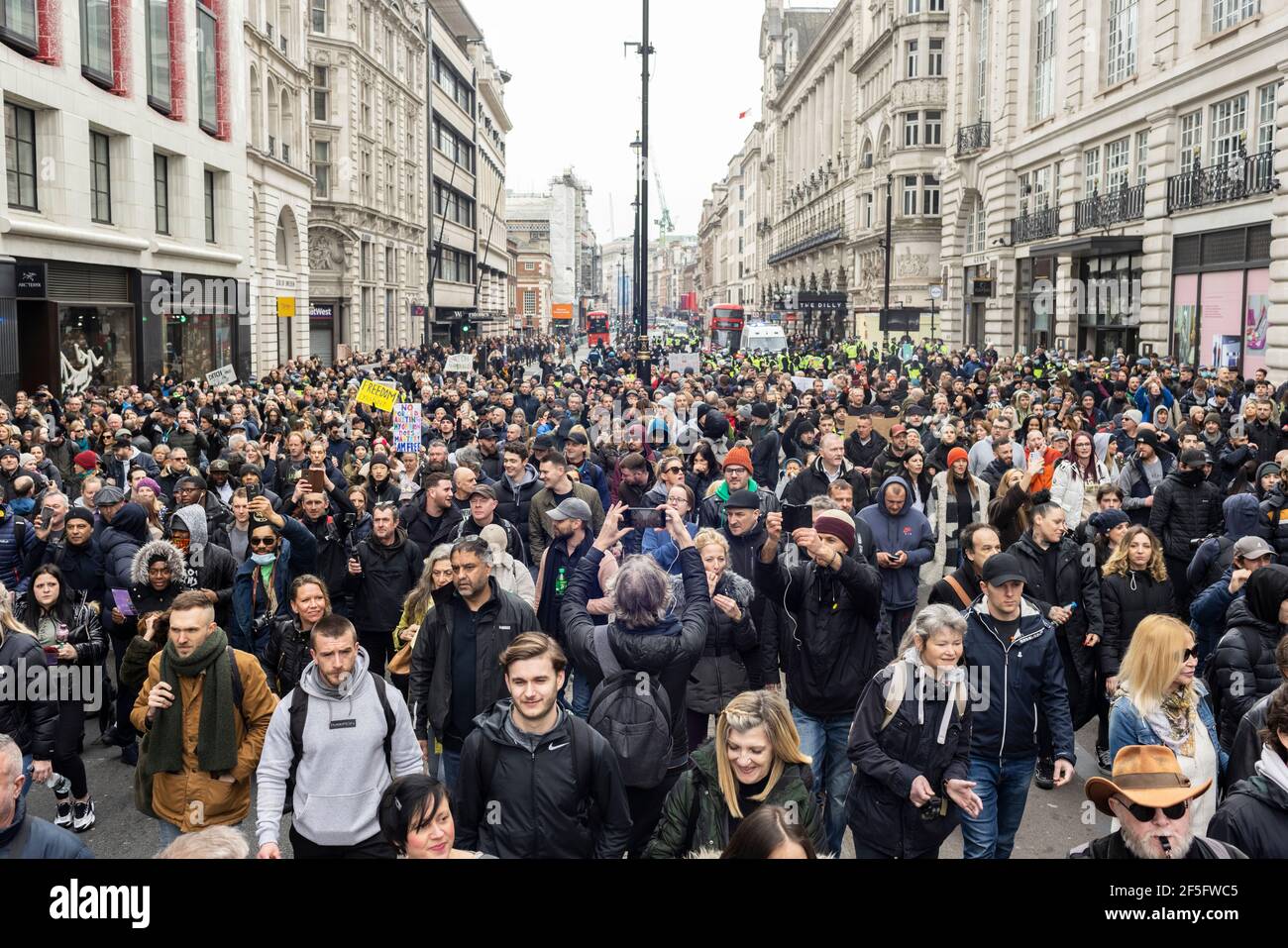 Anti-lockdown and anti Covid-19 vaccination protest, London, 20 March 2021. Crowd of marching protesters. Stock Photo