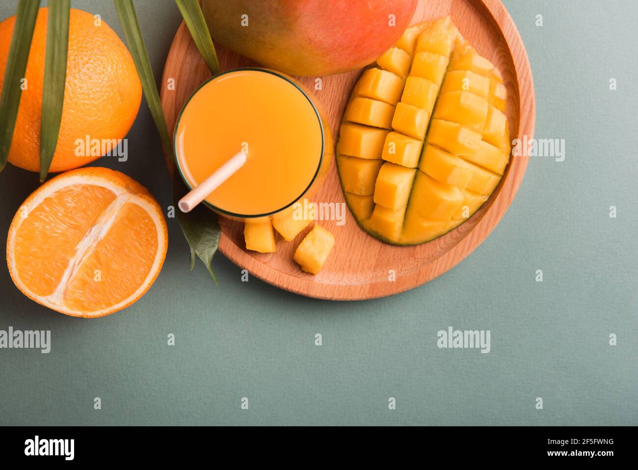 Fresh mango orange juice with ripe mangoes and orange fruit Stock Photo