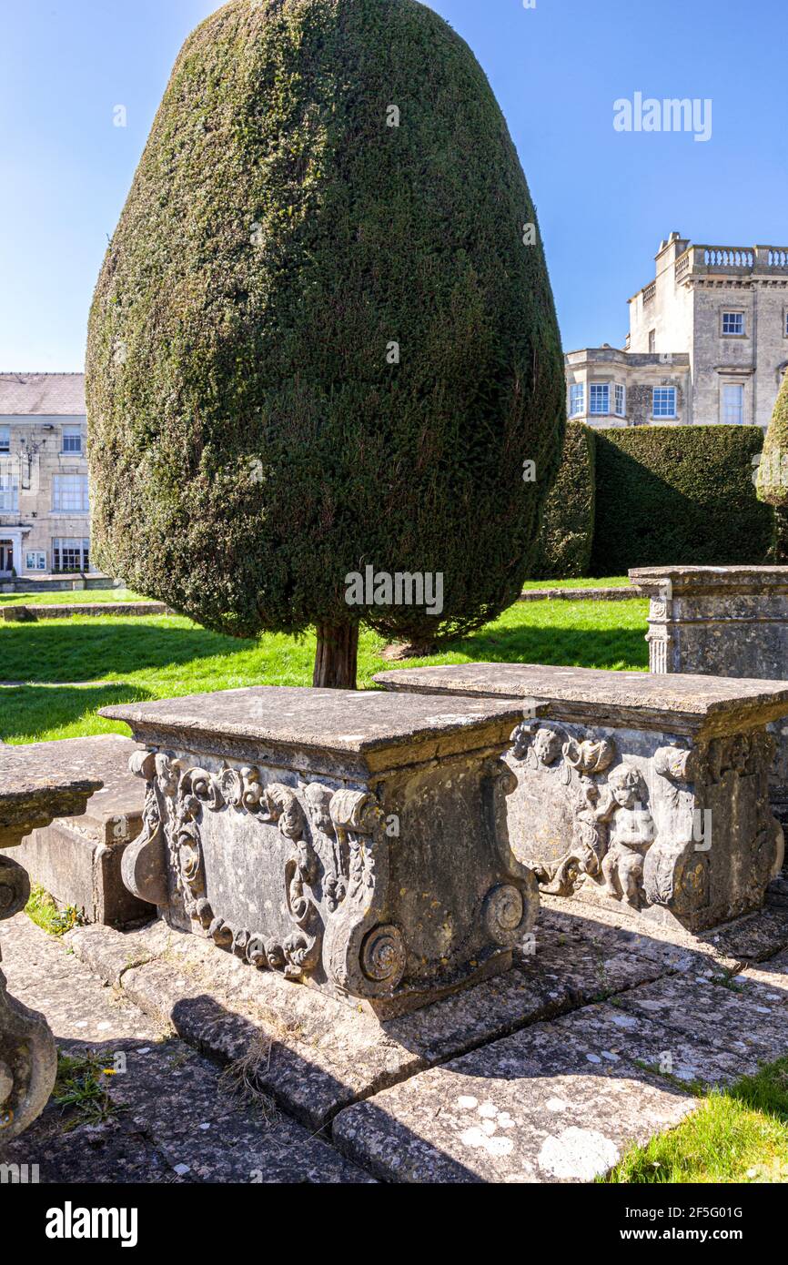 Carved stone table top tombs in the graveyard of St Marys church in the Cotswold village of Painswick, Gloucestershire UK Stock Photo