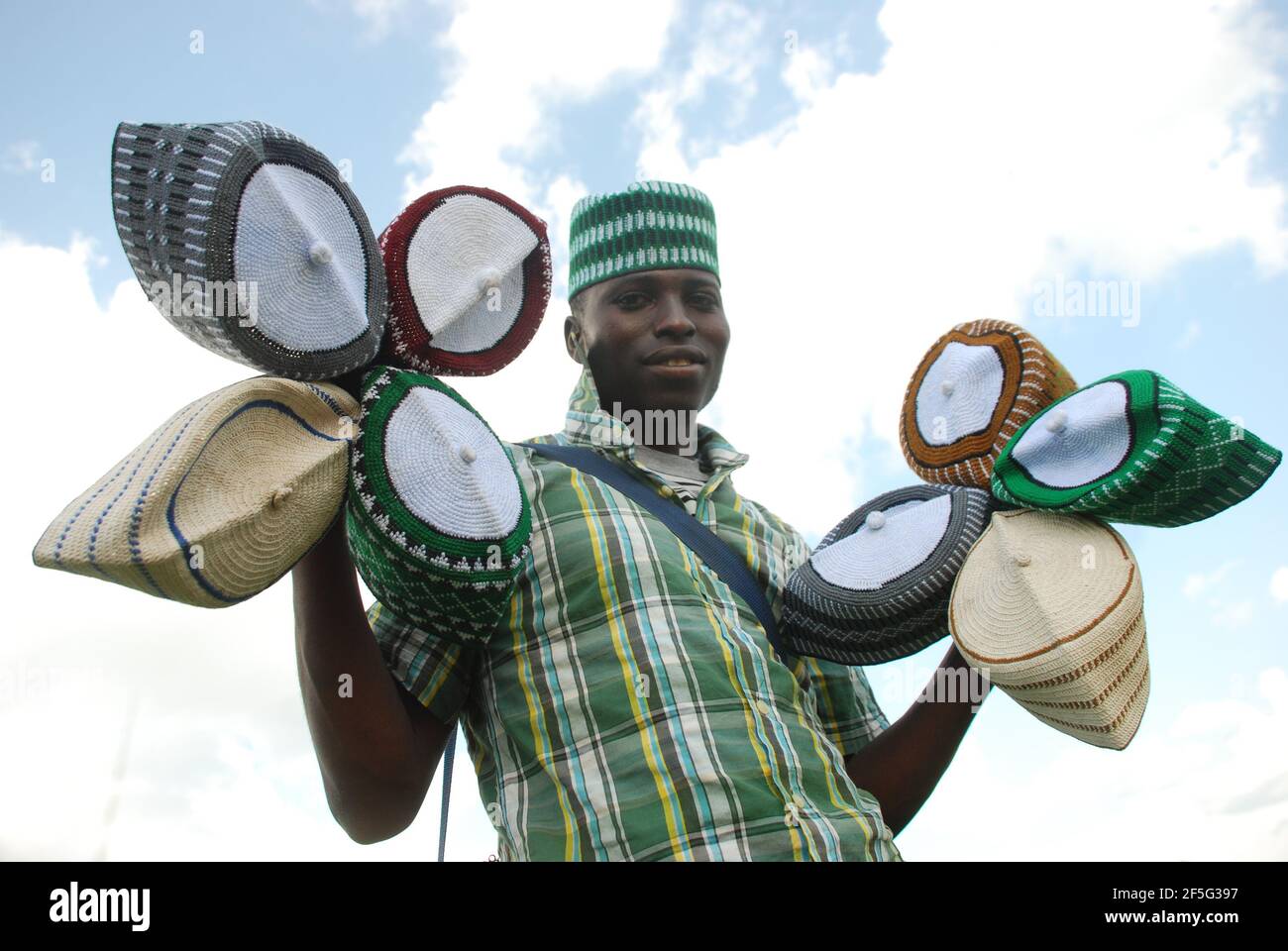 A man hawking Hausa Traditional Cap, Kogi State, Nigeria. Stock Photo