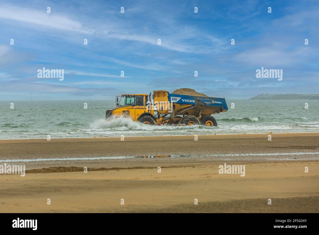 IJmuiderslag, IJmuiden, province of North Holland, The Netherlands, March 25, 2021: Volvo Dumper Volvo A30D transported sand Stock Photo