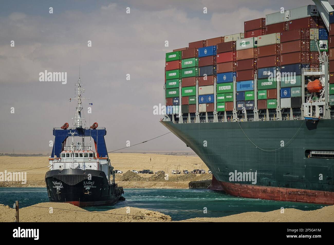 Suez Canal, Egypt. 26th Mar, 2021. A tugboat takes part in the ...