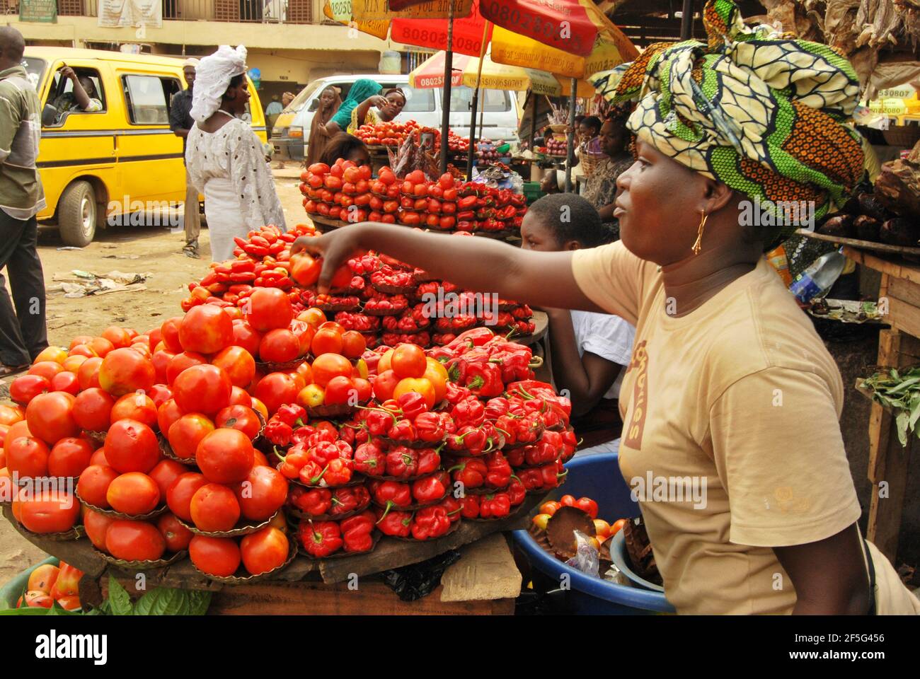 African lady selling Tomato at a local market in Lagos, Nigeria. Stock Photo