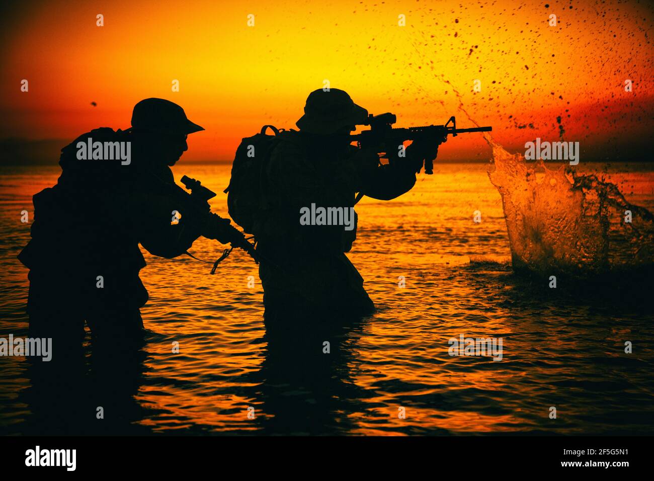 Army soldiers team, special operation forces infantrymen landing on seacoast, aiming and shooting with service rifle during firefight on shore at evening or morning time. Military amphibious operation Stock Photo