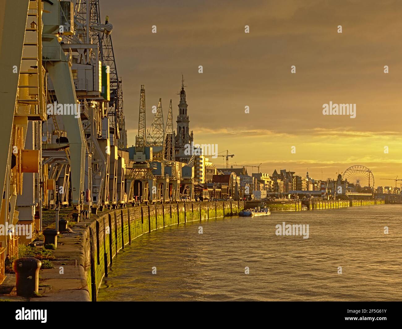 Quay along river Scheldt in the port of Antwerp, with old industrial ...