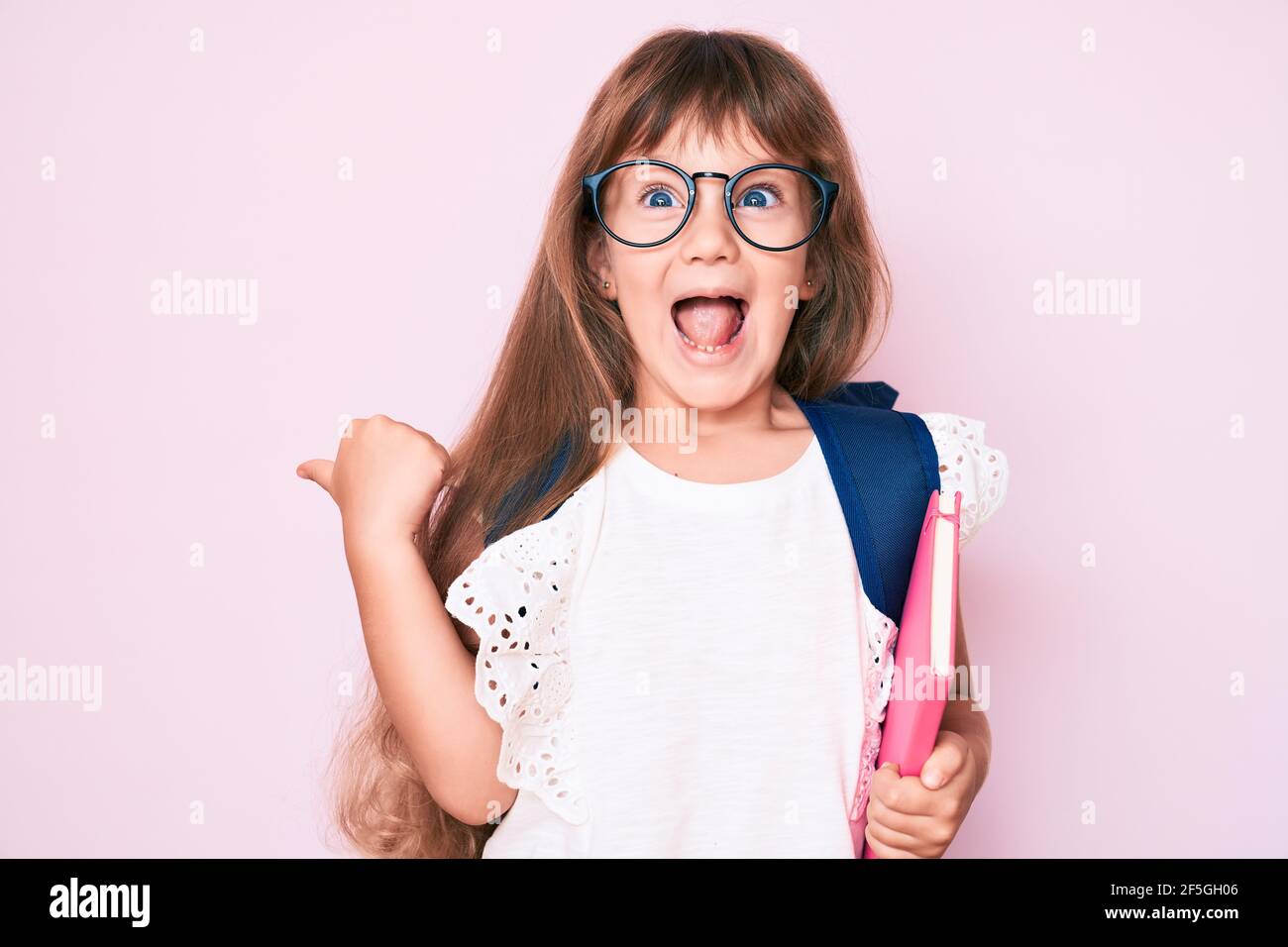 Little caucasian kid girl with long hair wearing student backpack and ...