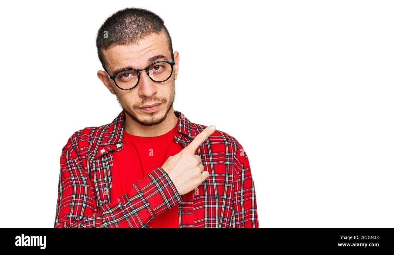 Hispanic Young Man Wearing Casual Clothes Pointing With Hand Finger To The Side Showing 3178