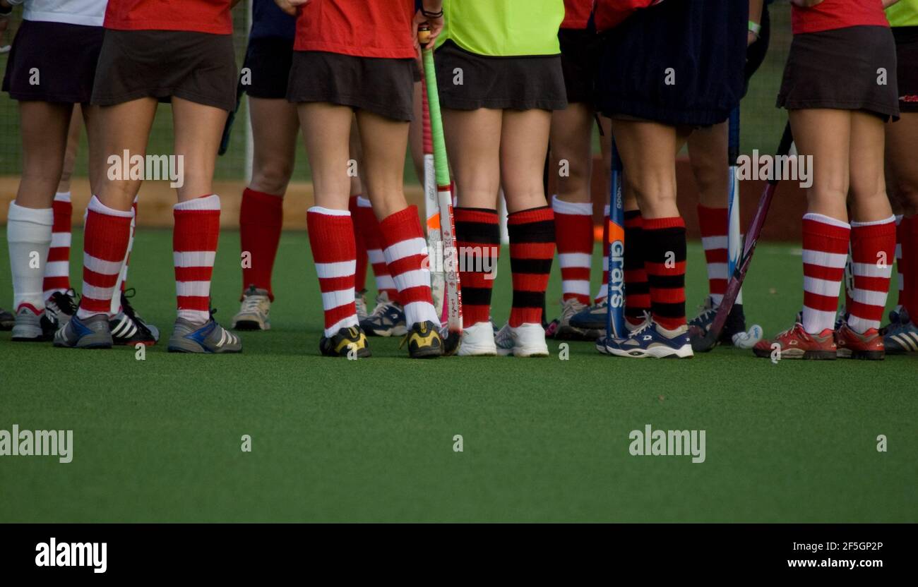 astroturf with legs of girls hockey team with empty space for caption at the bottom of the image Stock Photo