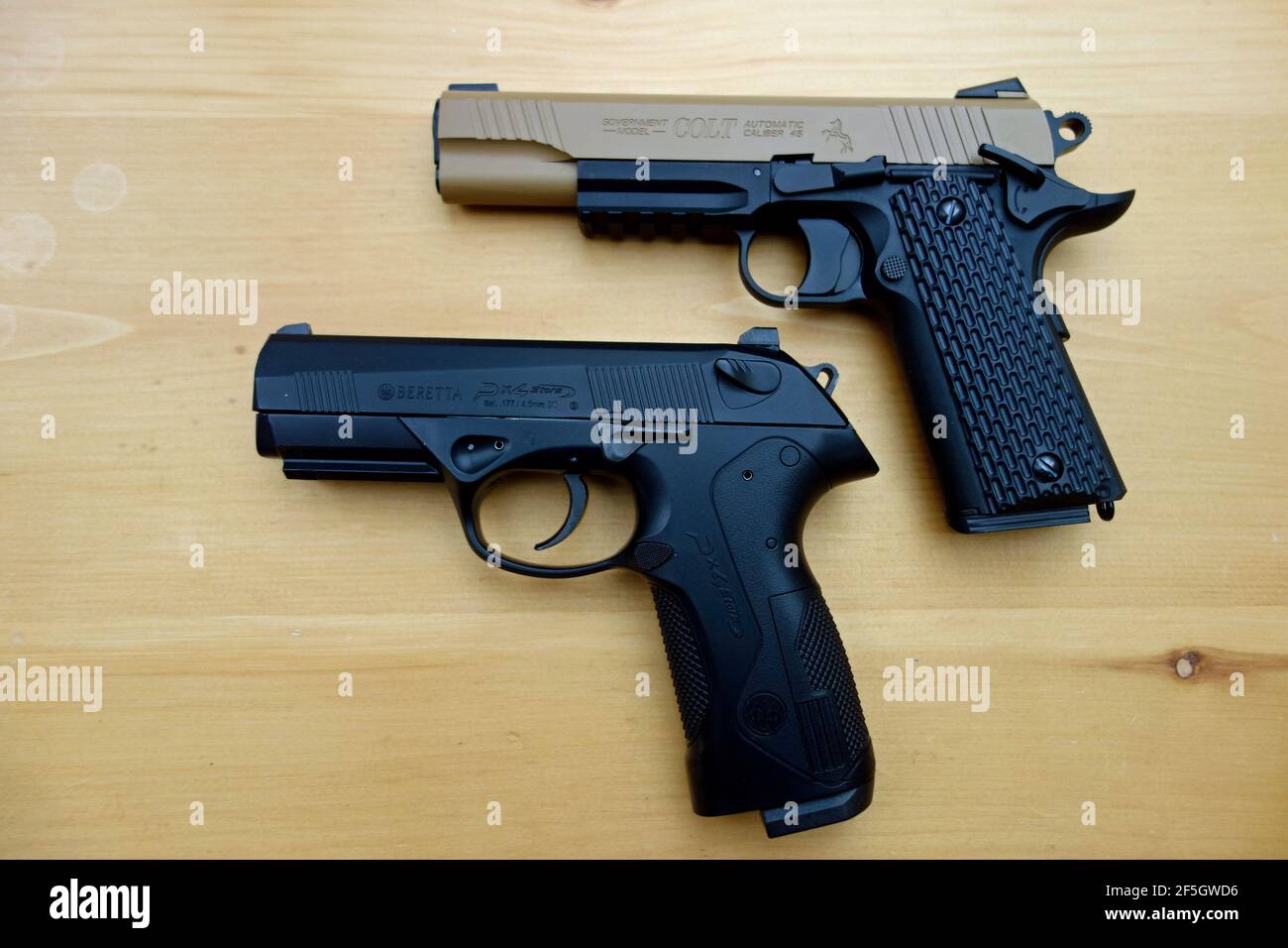 a Colt 45 auto and Beretta PX4 9mm replica handguns that shoot BBs or pellets by CO2 air Stock Photo