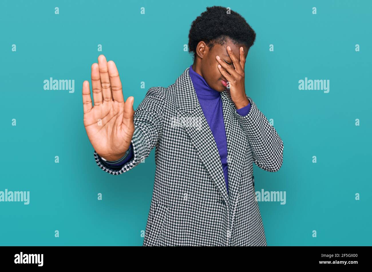 Young african american girl wearing casual clothes covering eyes with hands and doing stop gesture with sad and fear expression. embarrassed and negat Stock Photo