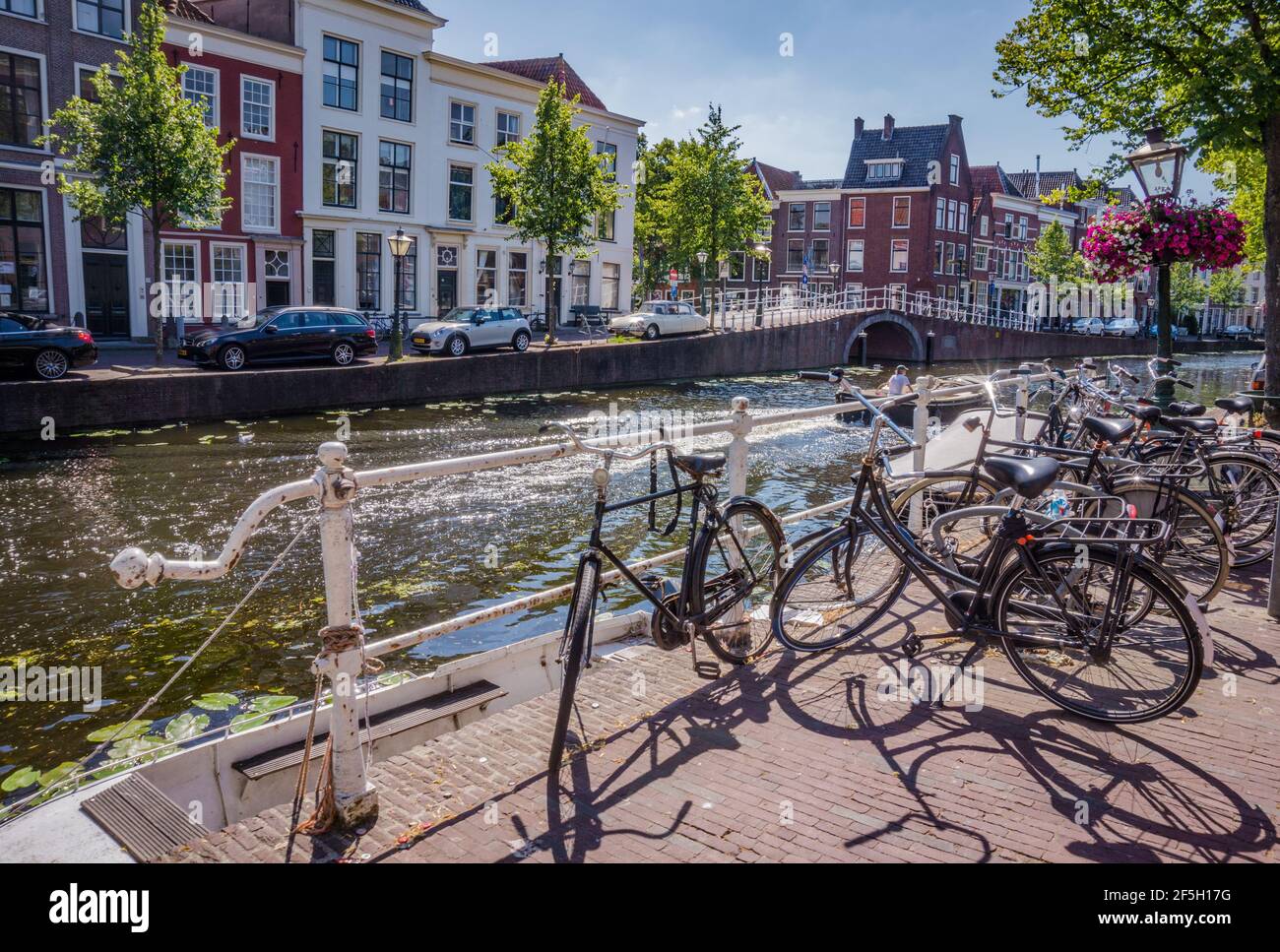 Bunch of bicycles standing by canal in Leiden, the Netherlands Stock Photo