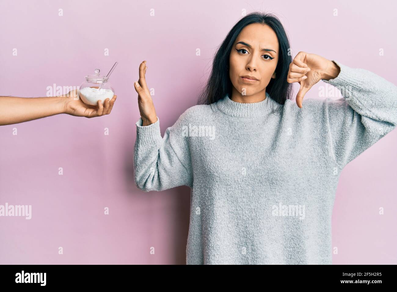 Young hispanic girl rejecting bowl with sugar with angry face, negative ...