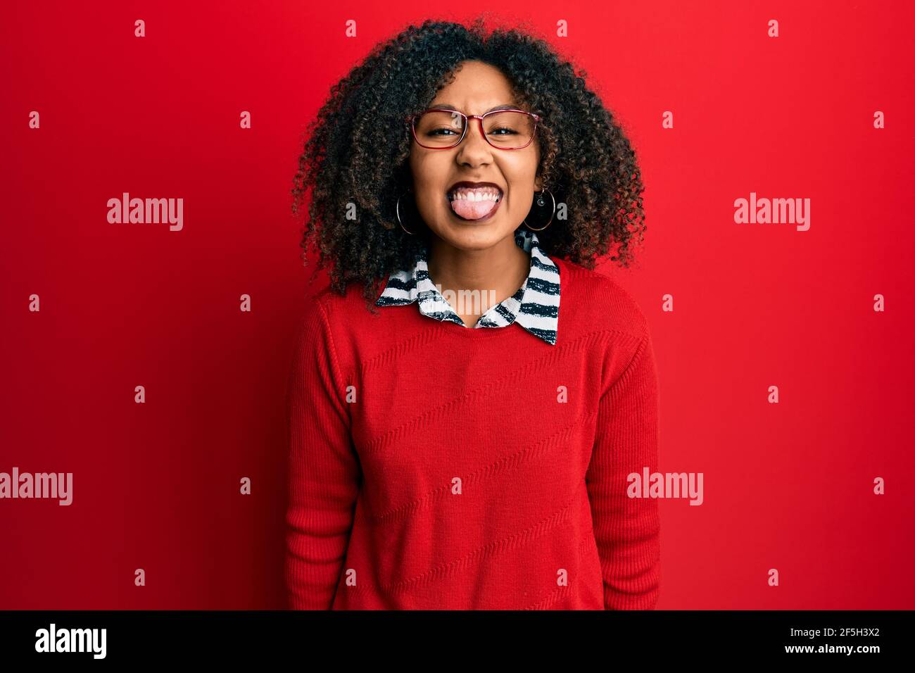 Beautiful african american woman with afro hair wearing sweater and ...